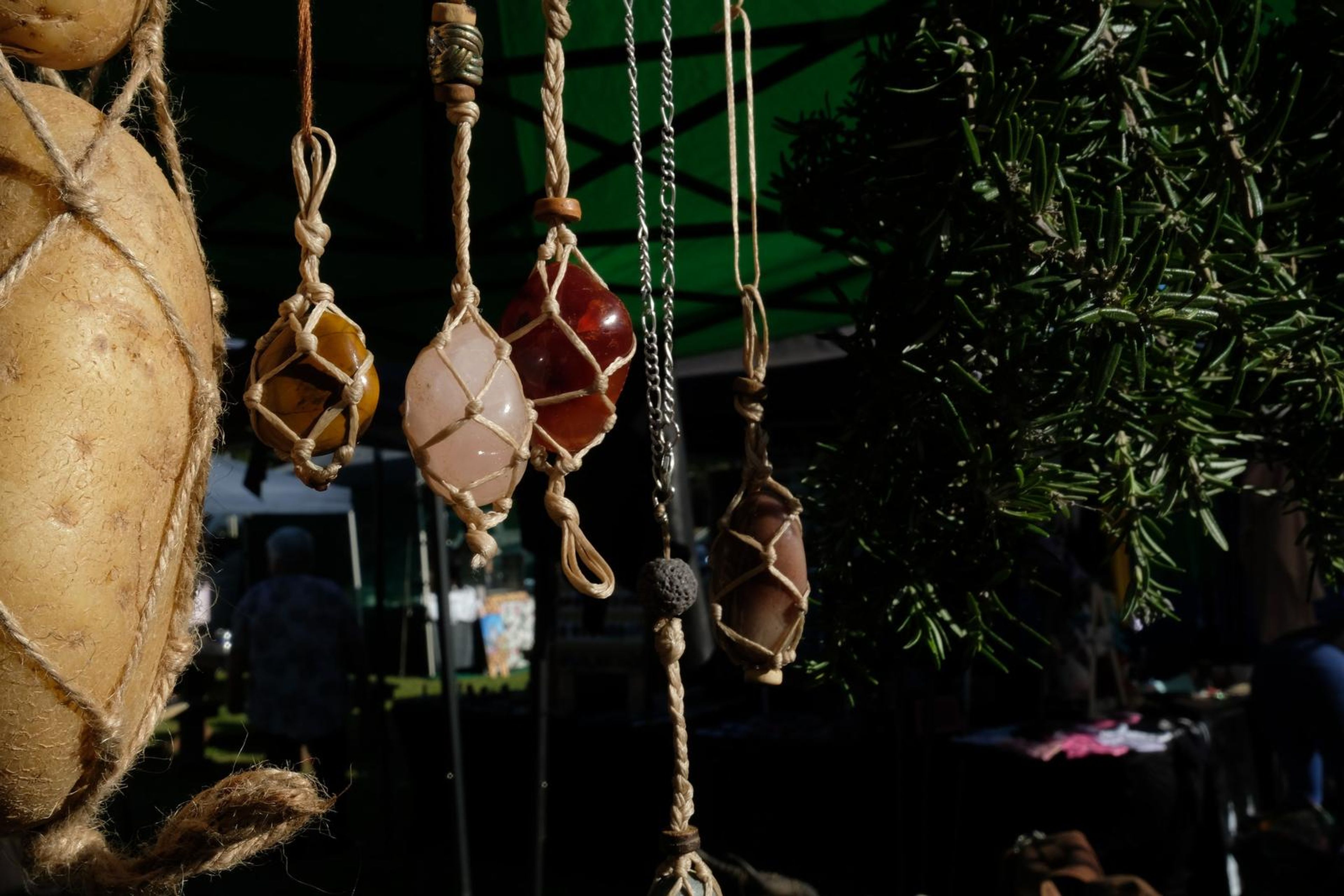 Wire-wrapped crystal pendants hanging from the stall canopy