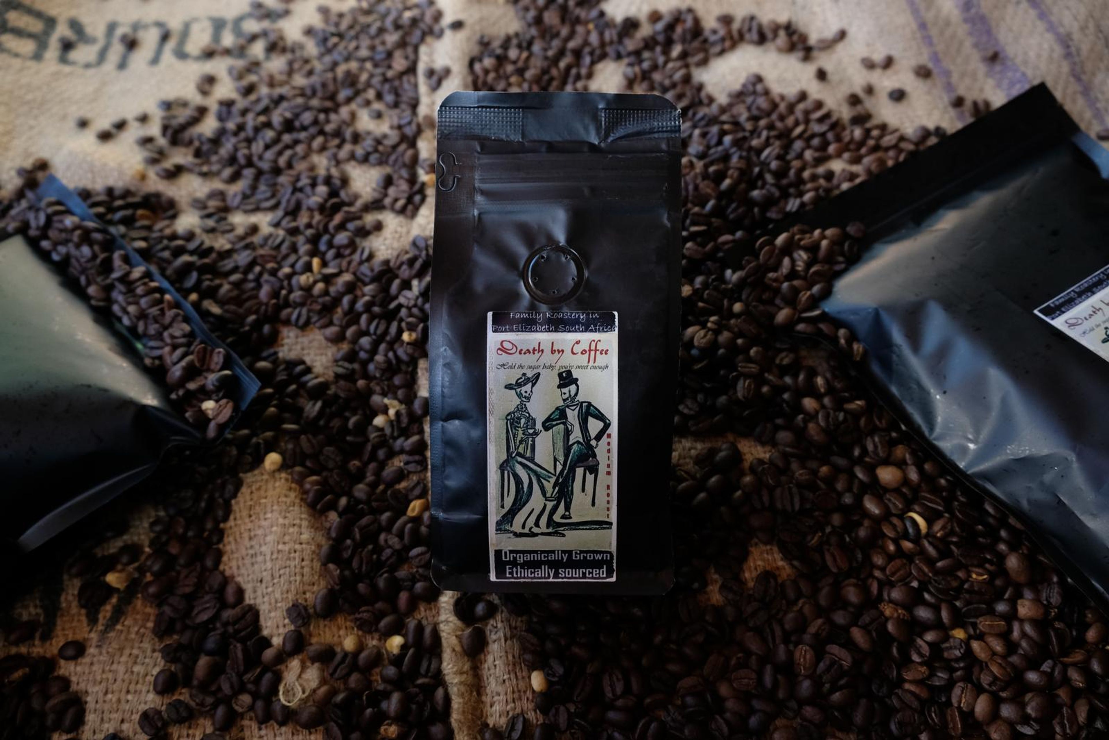 Death By Coffee creative product photography of coffee, beans and branded bags