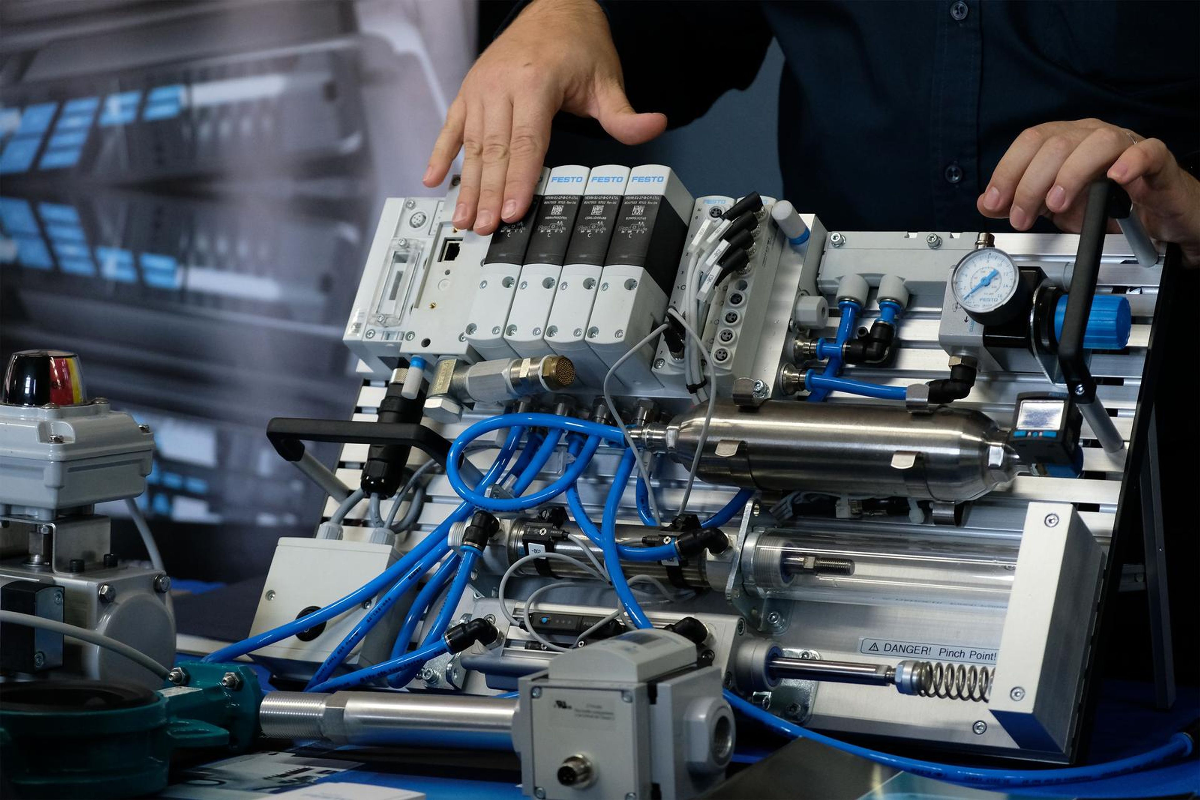 Festo pneumatic demonstration with a technician adjusting the valves