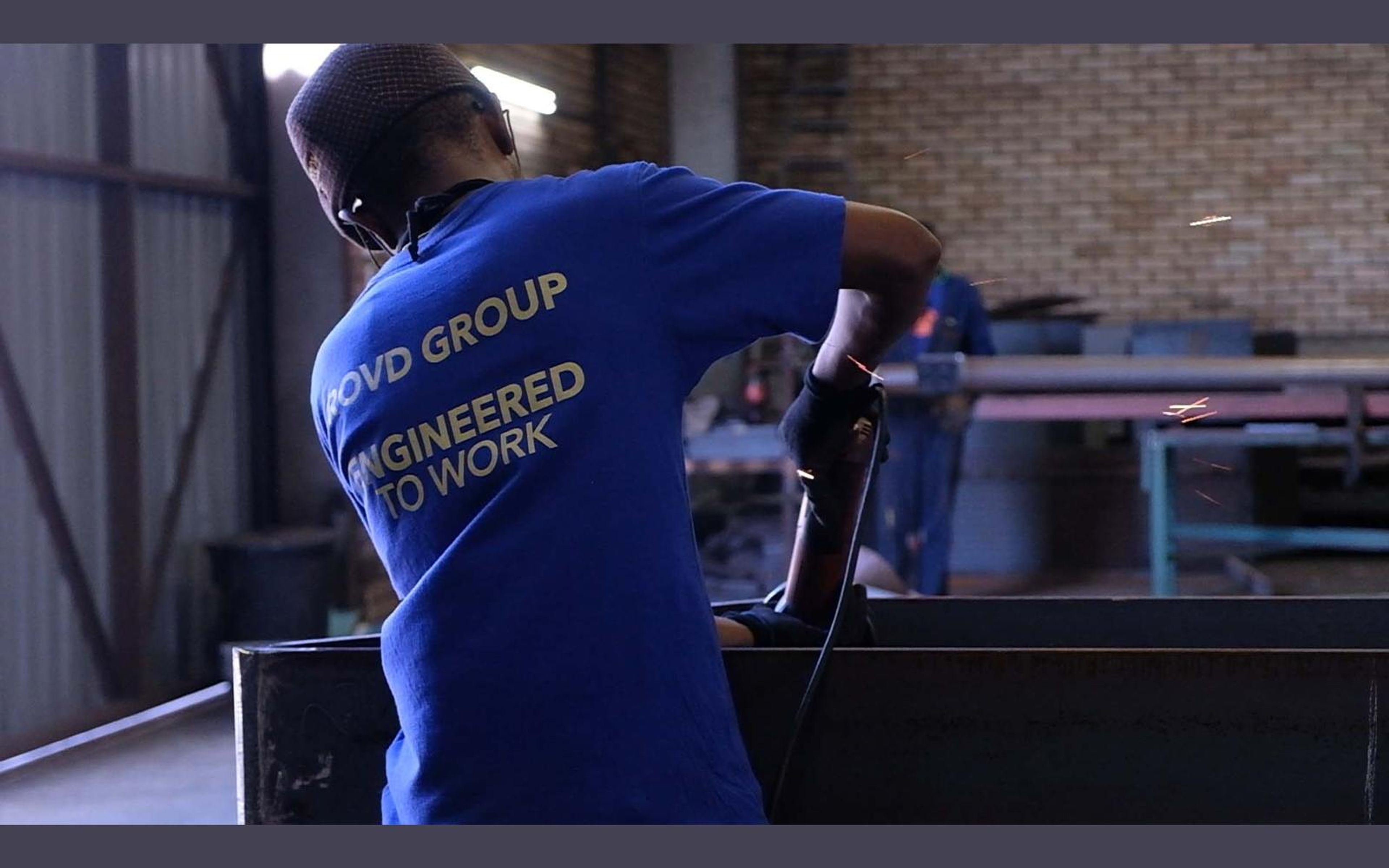 Fabricator in a ROVD Engineered to Work shirt at the bench