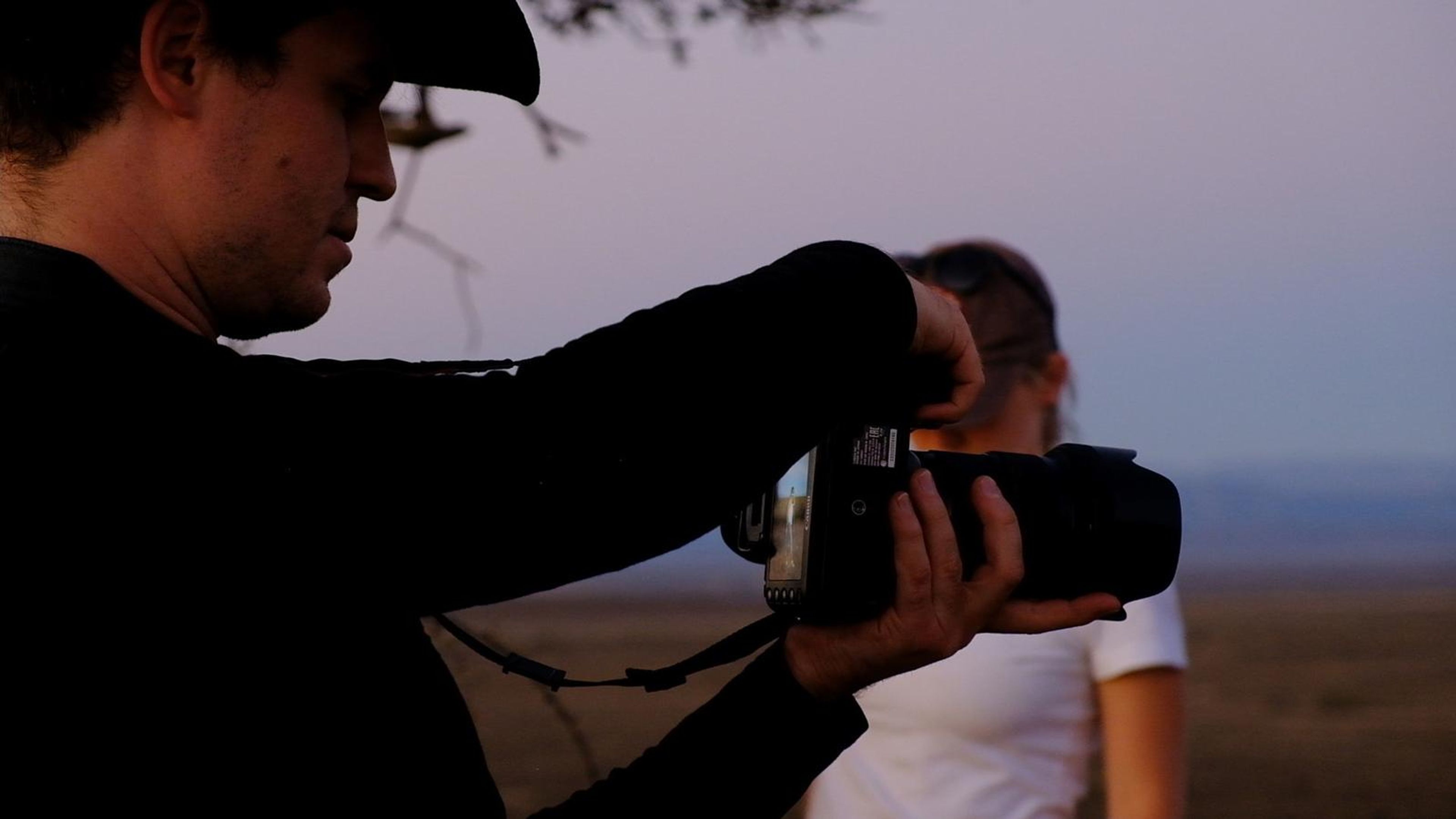 Photographer lining up a shot at dusk