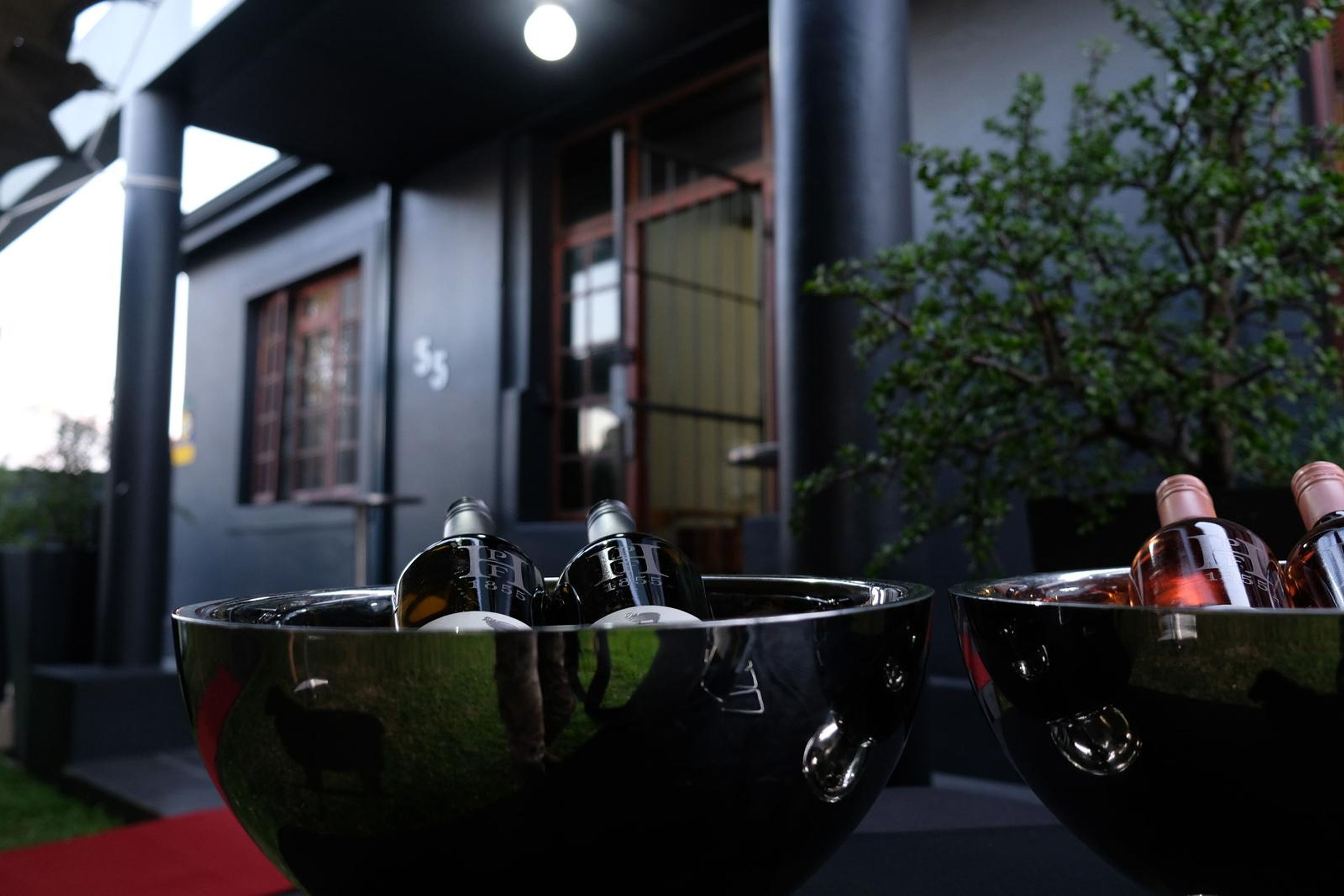 Two silver ice buckets of white and rose wine on the opening-night terrace
