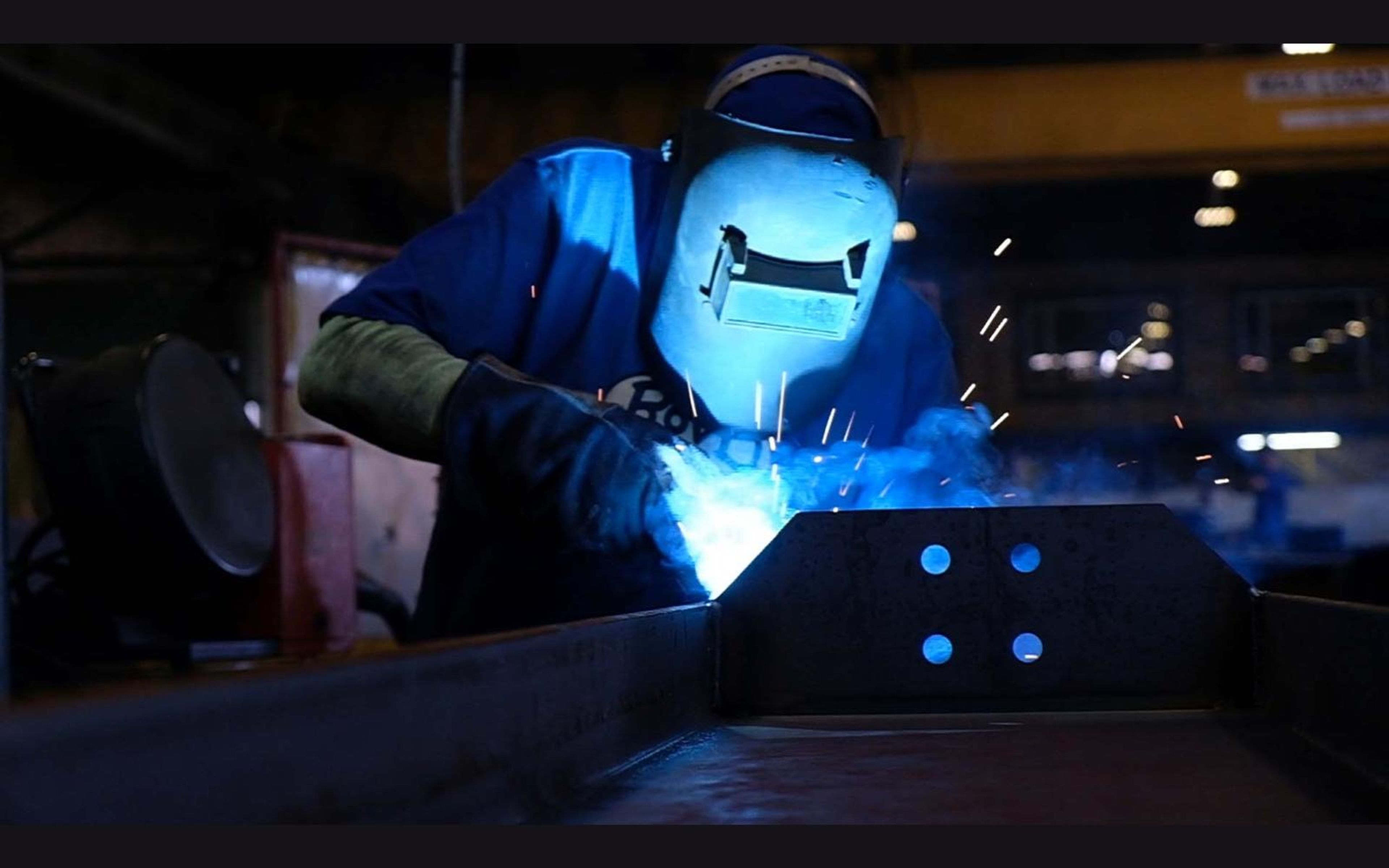 Close view of a welder's torch and glowing weld