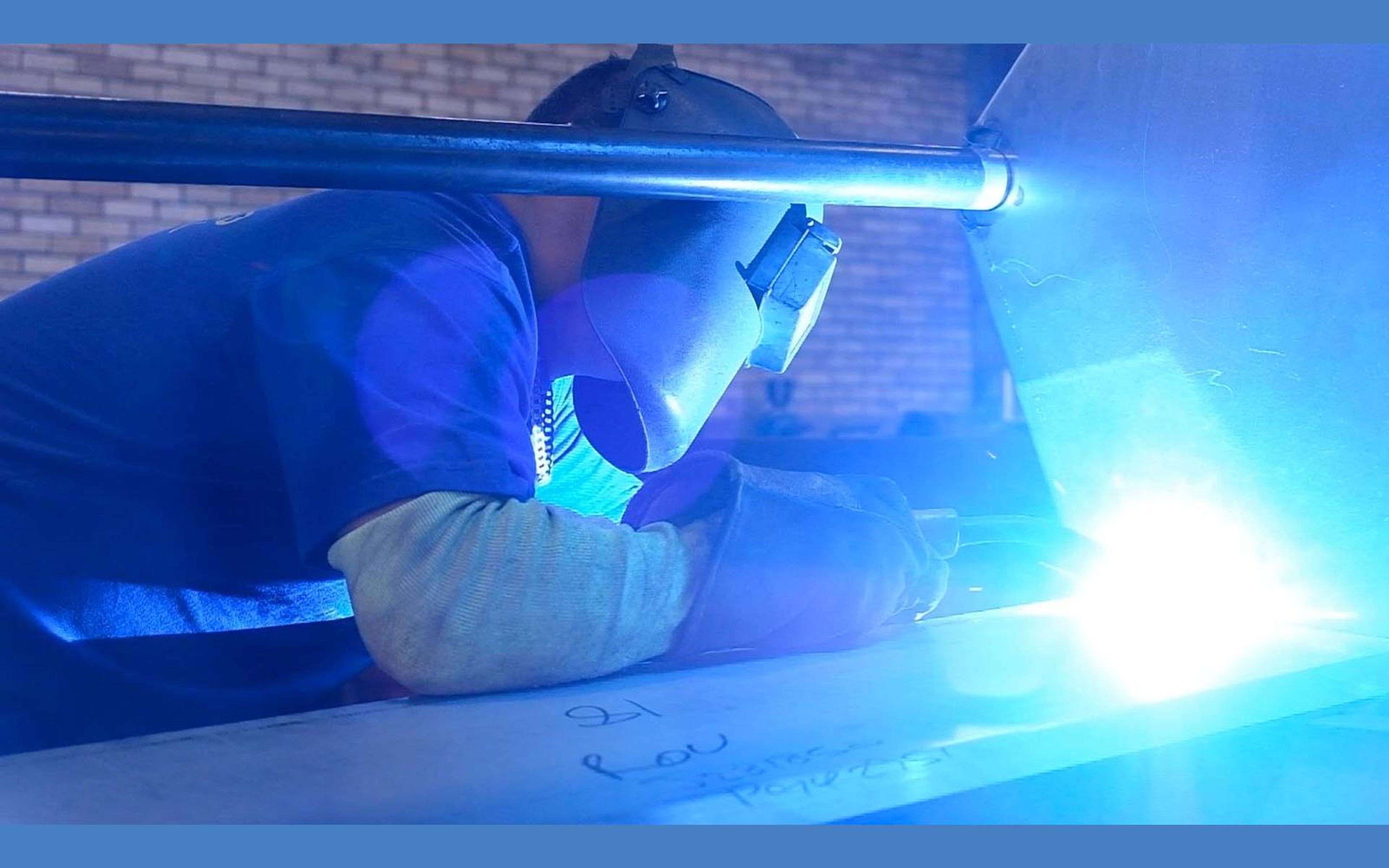 Welder at work with sparks and arc light