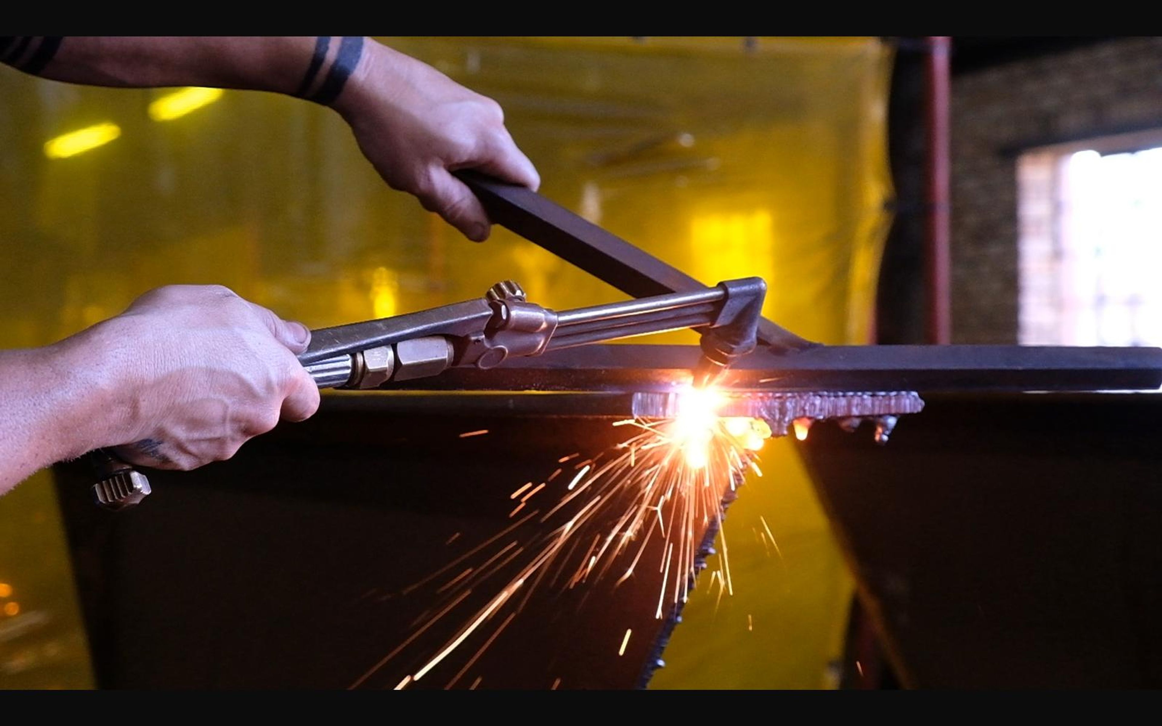 Cutting torch throwing sparks off steel