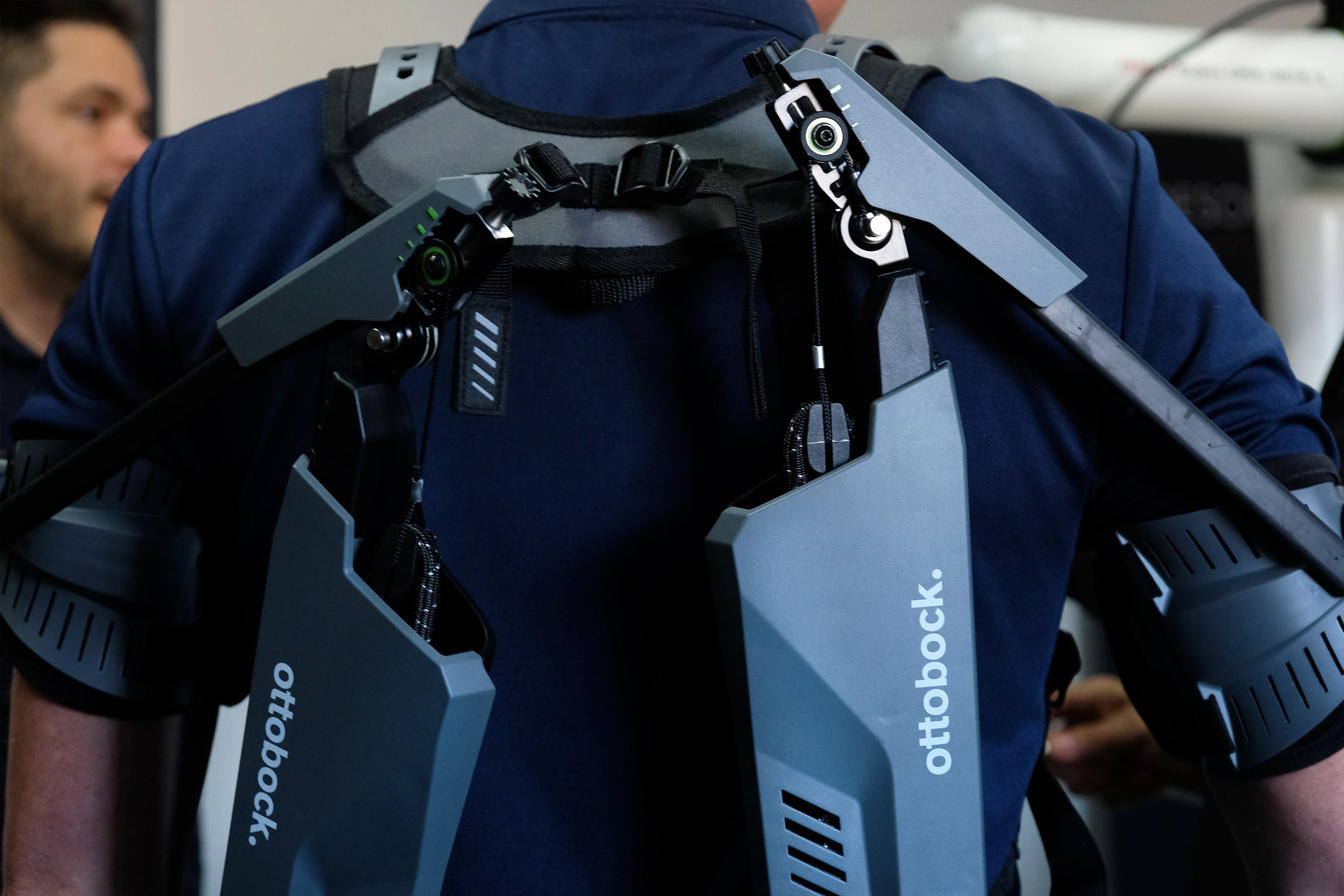 Ottobock exoskeleton worn by a visitor, seen from behind at the SuitX stand
