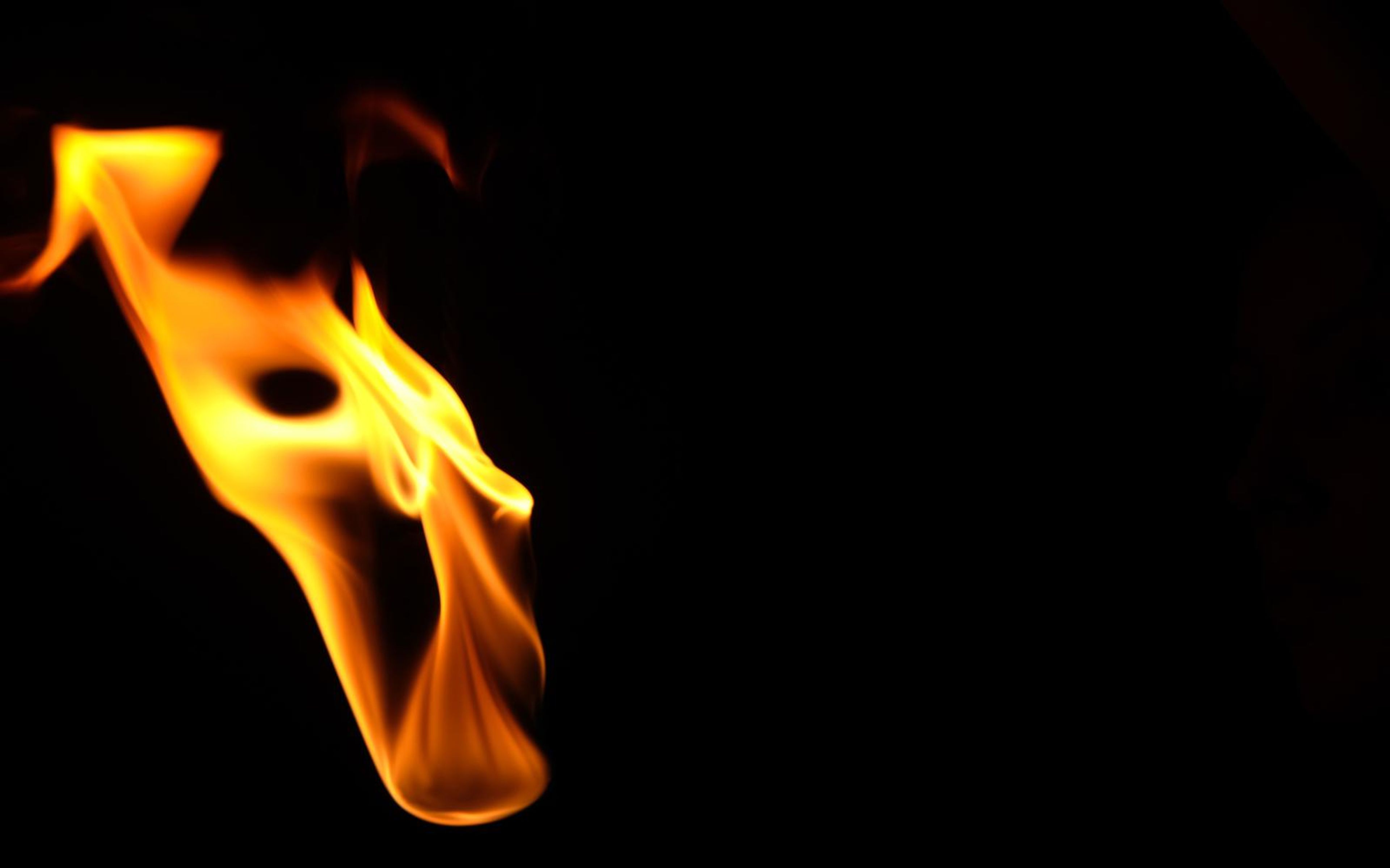 Flame at the left edge angled downward with a small round hole near the top