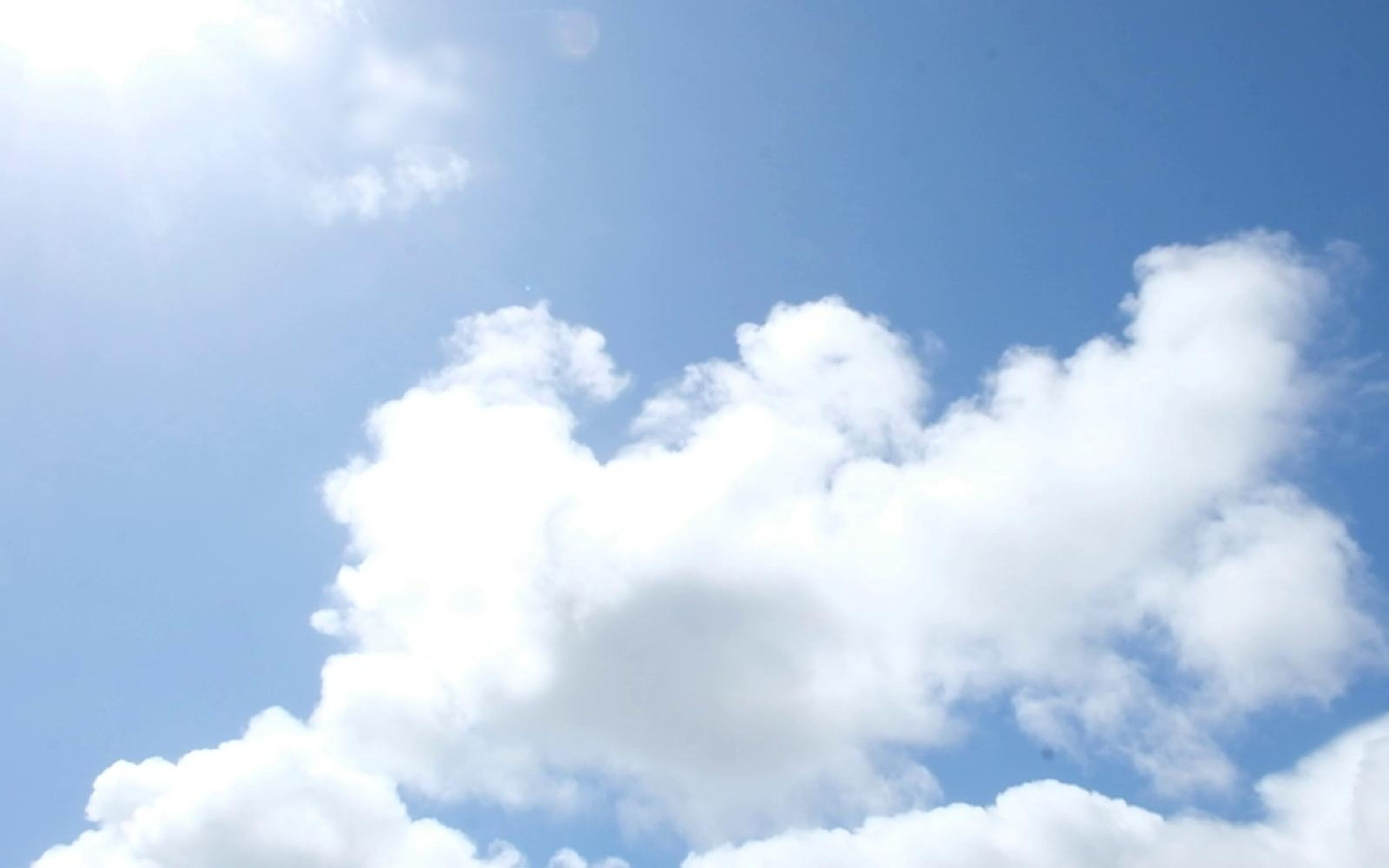 Bright white cumulus cloud in a deep blue sky