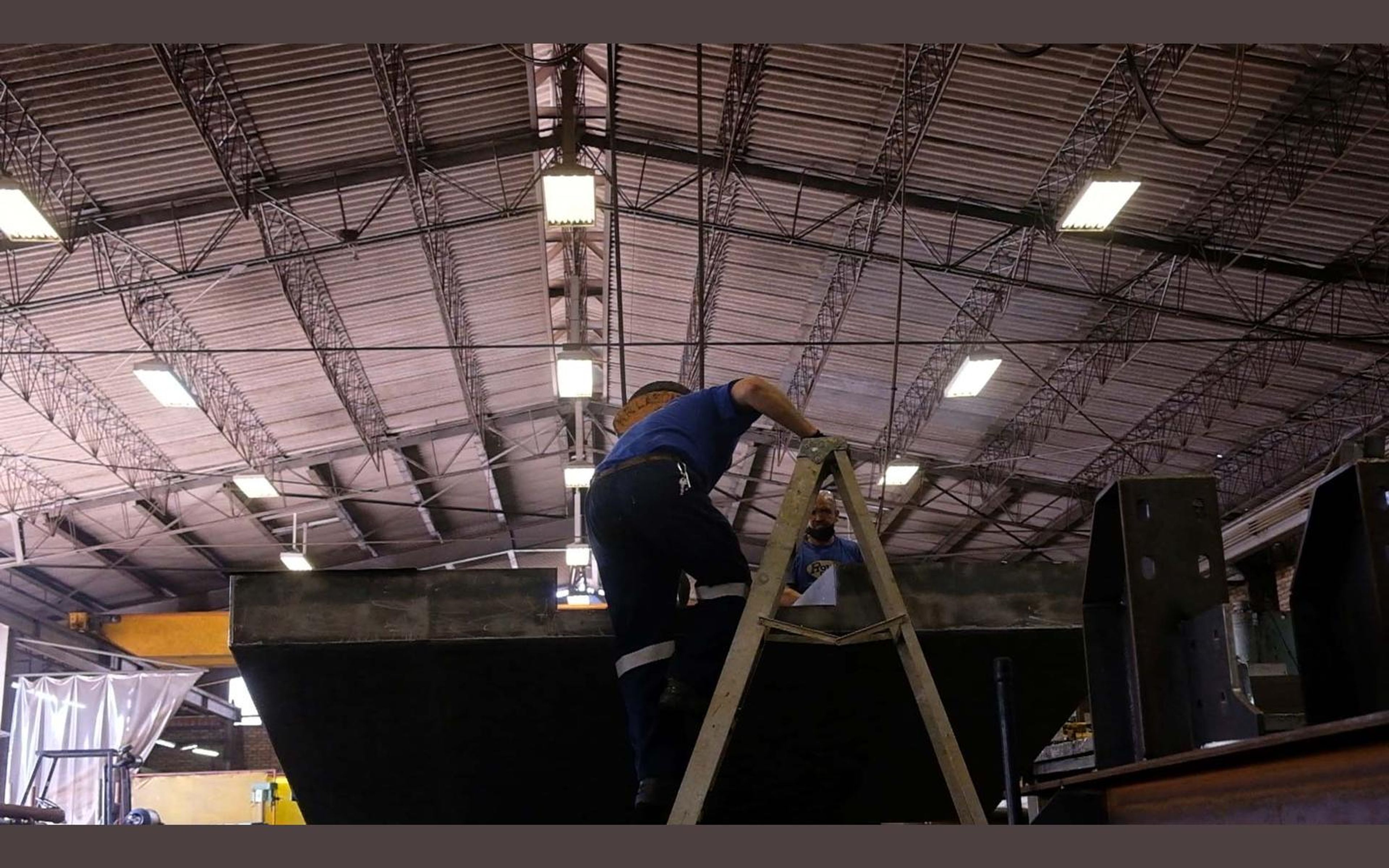 Wide view of the fabrication sector with steel frames on the floor