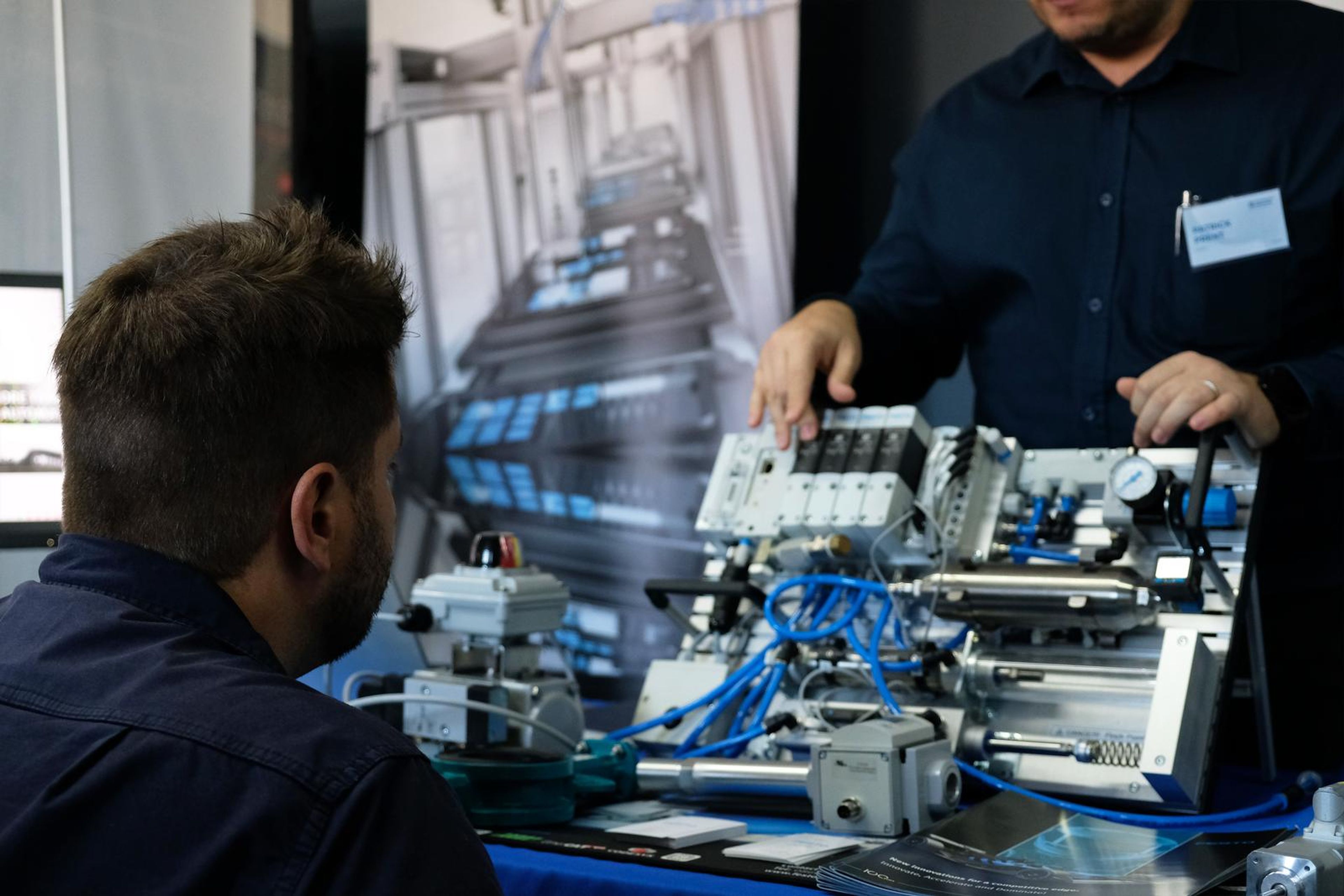 Two visitors at a Festo pneumatic demonstration