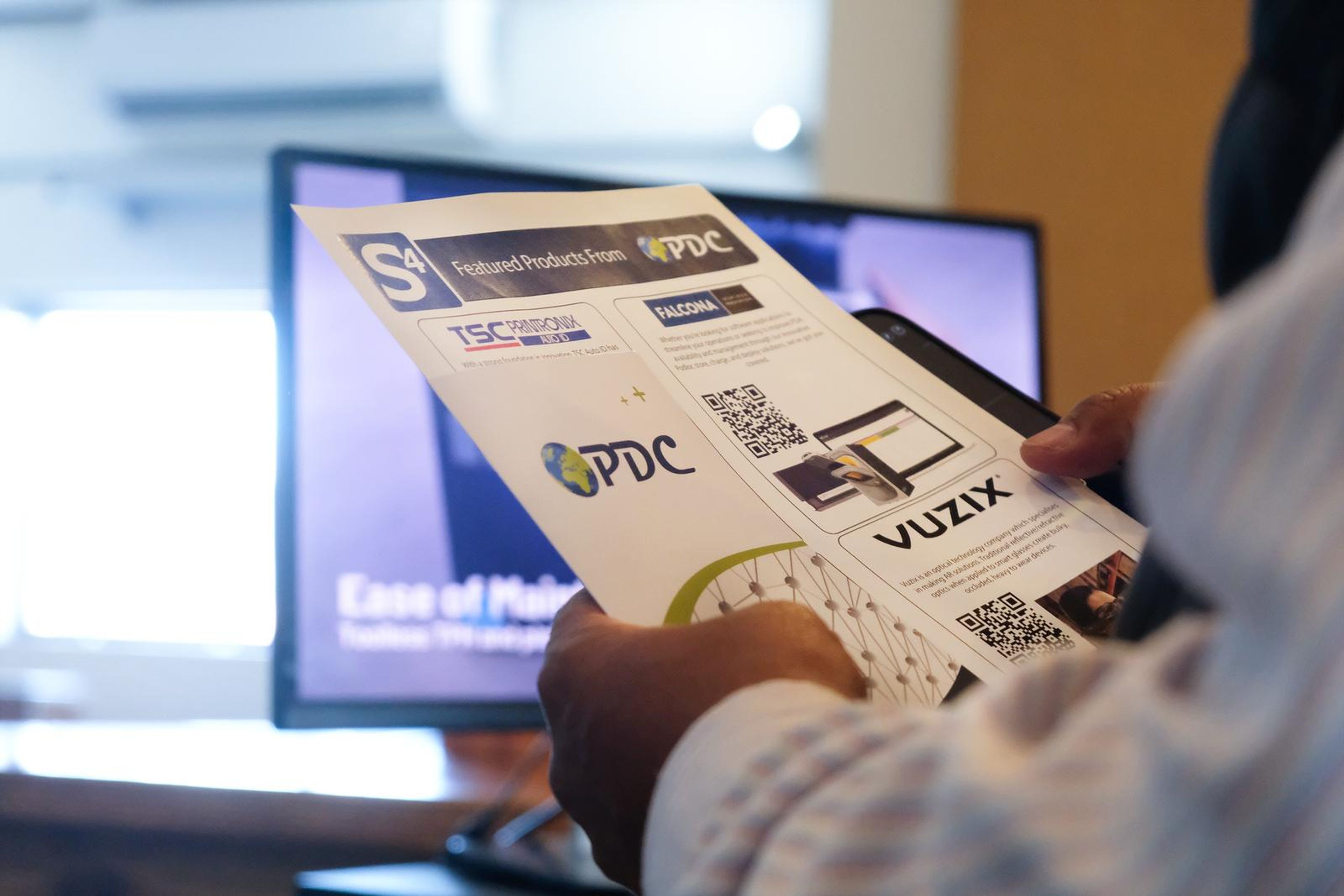 Visitor reading a PDC and Vuzix flyer