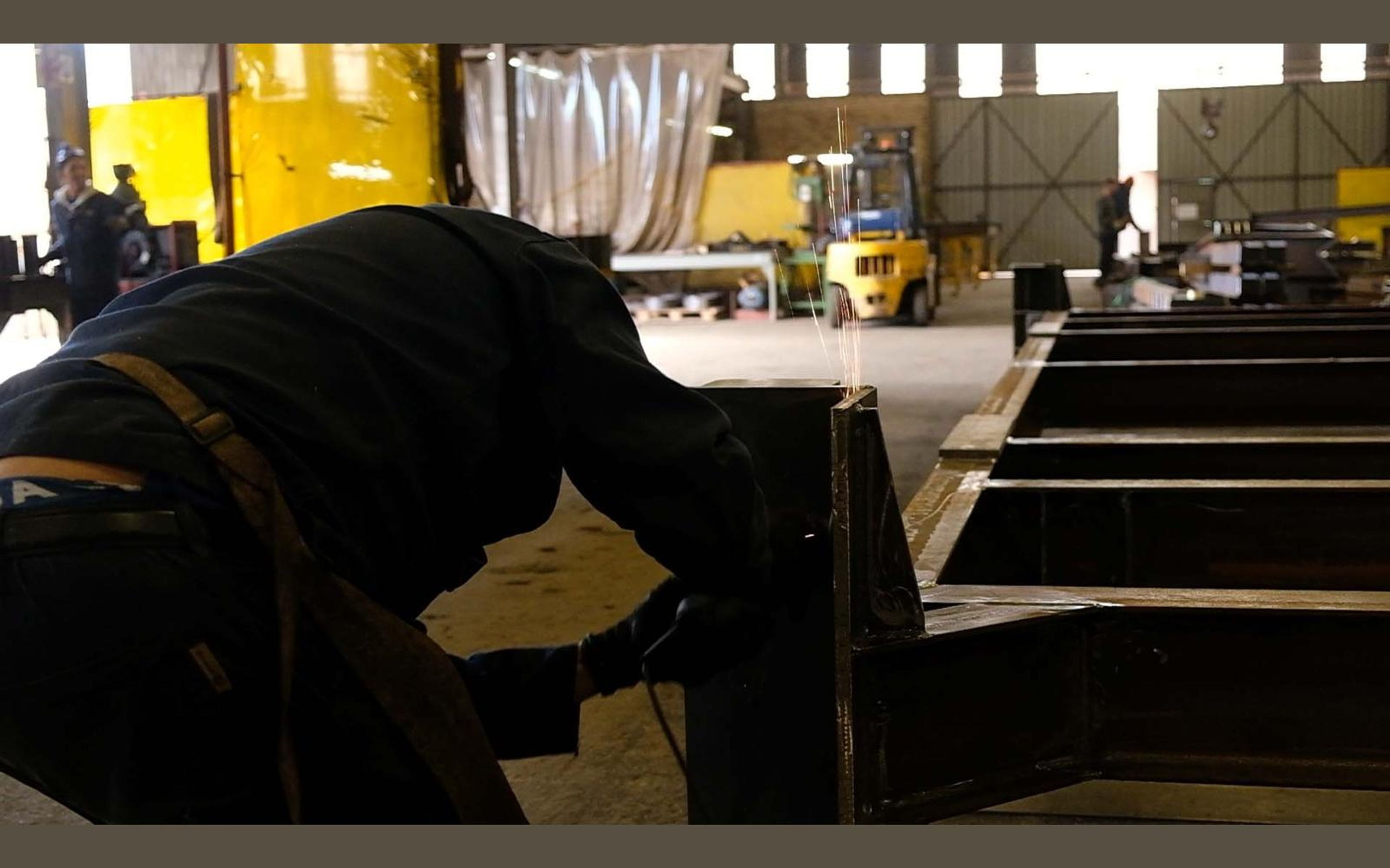 Steel frames laid out across the fabrication sector floor