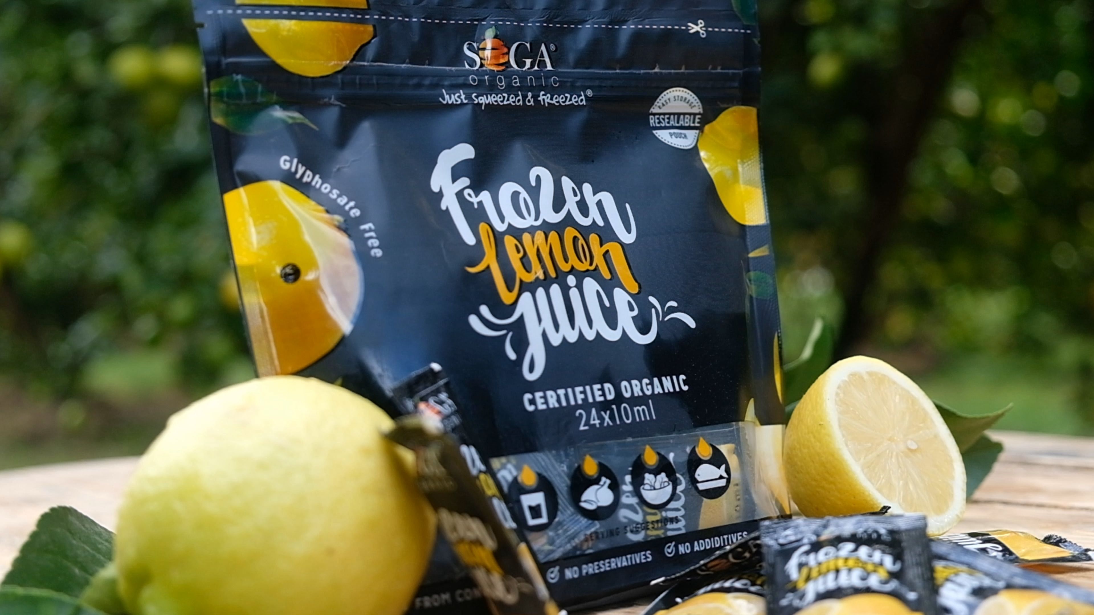 SOGA frozen lemon juice pouch with lemons and sachets on a wooden table