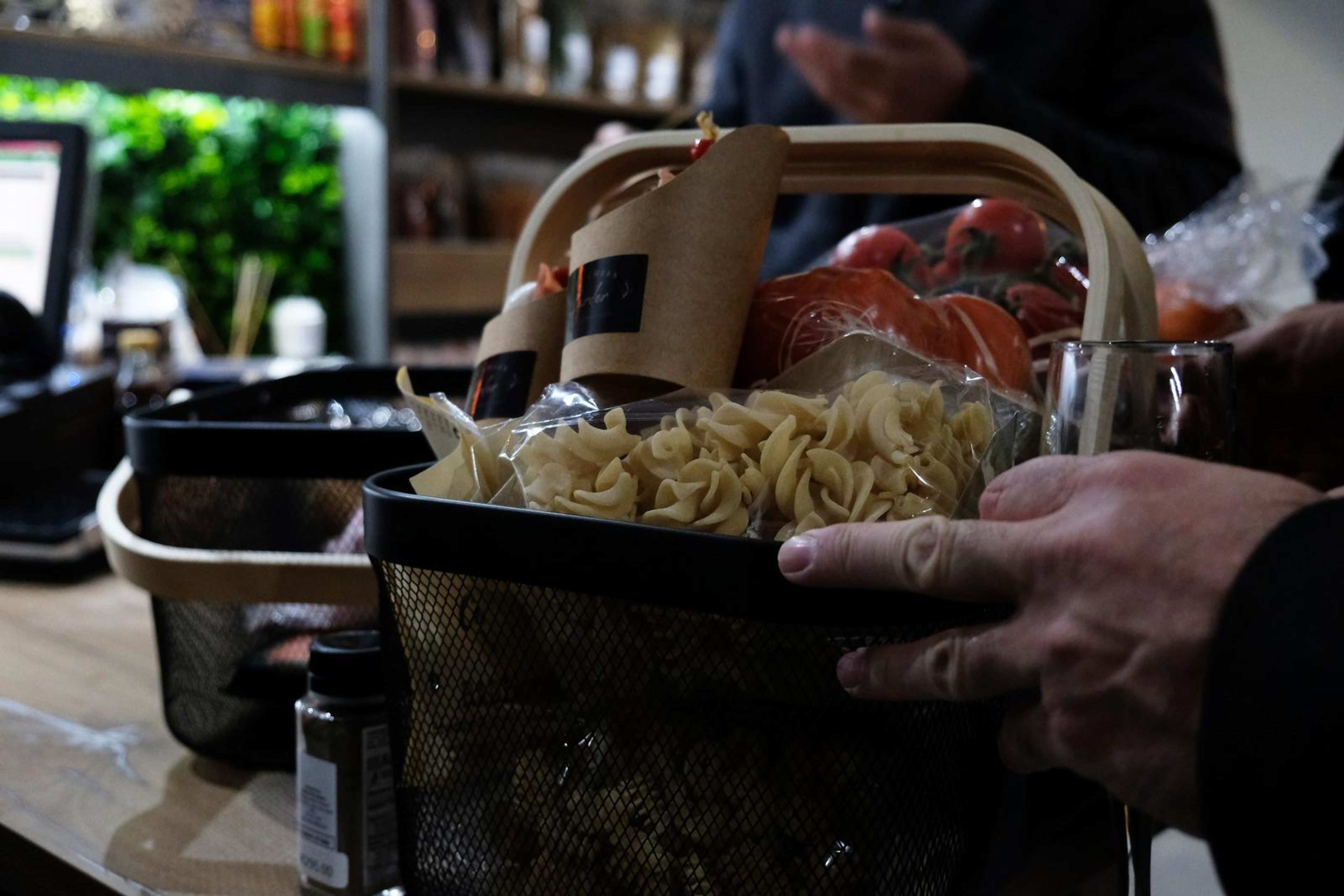 Close-up of a gift pack and tomatoes in a basket on the counter