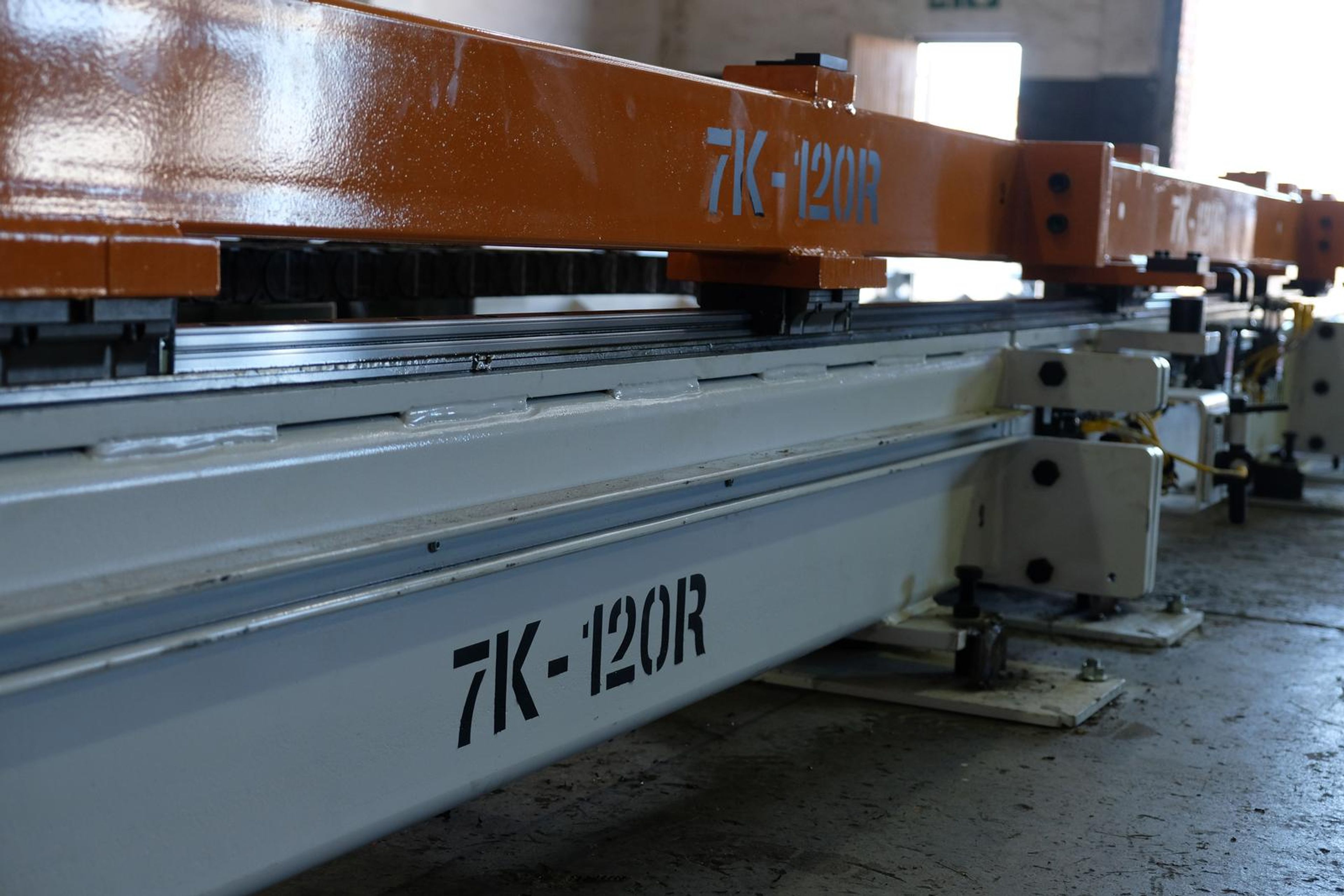 Orange beam stencilled 7K-120R above a white steel rail