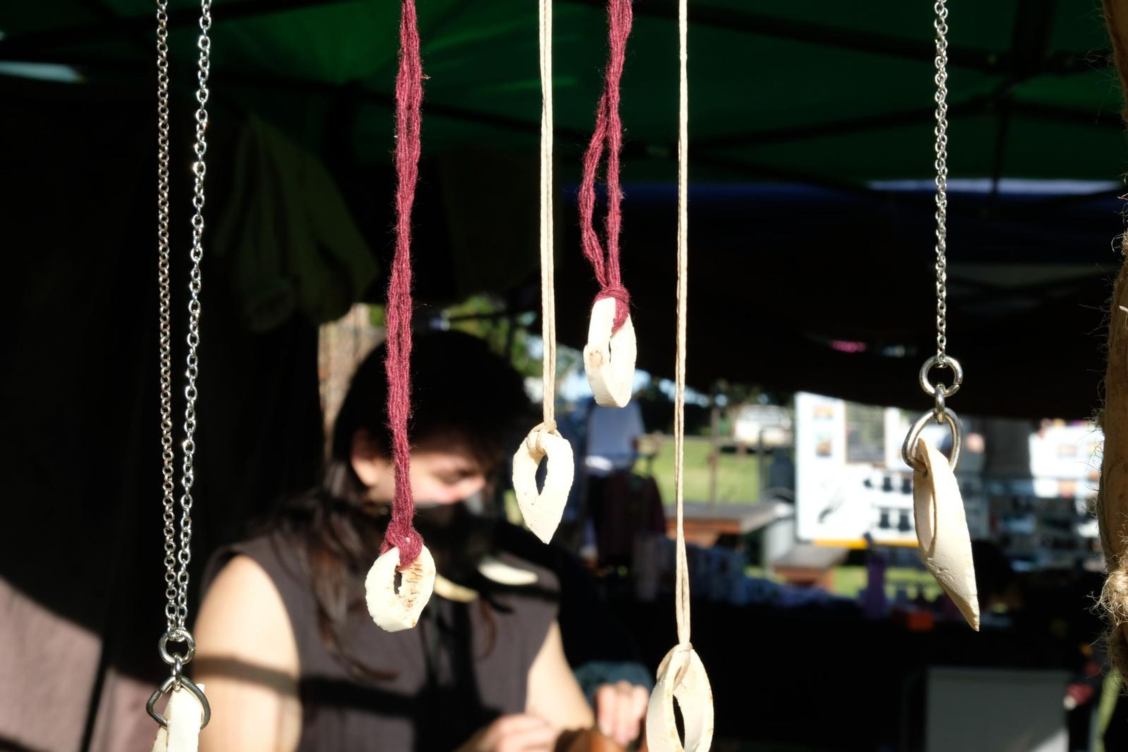 Bone and shell pendants hanging on cords and chains