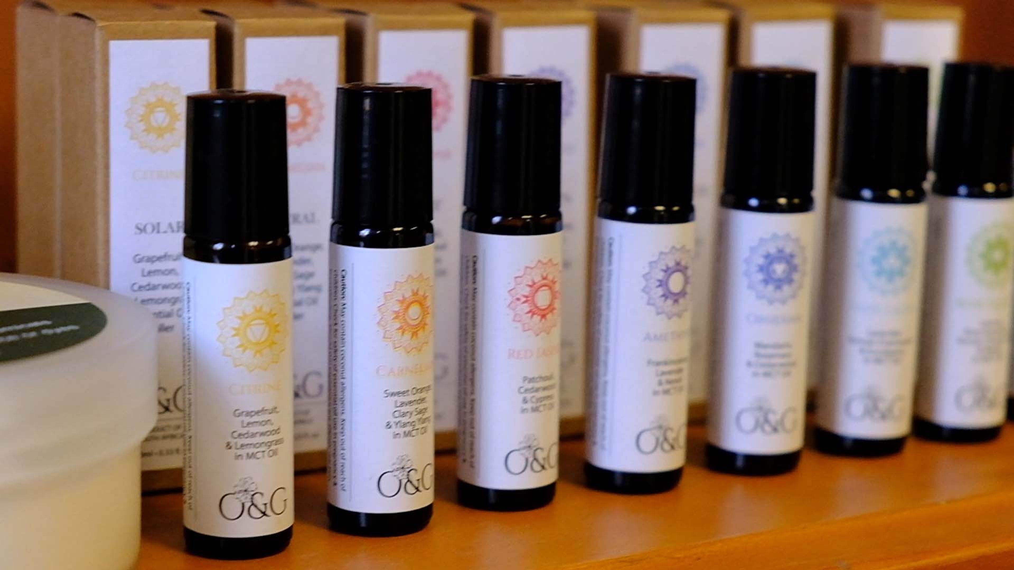 A row of roll-on essential oil bottles on a shelf