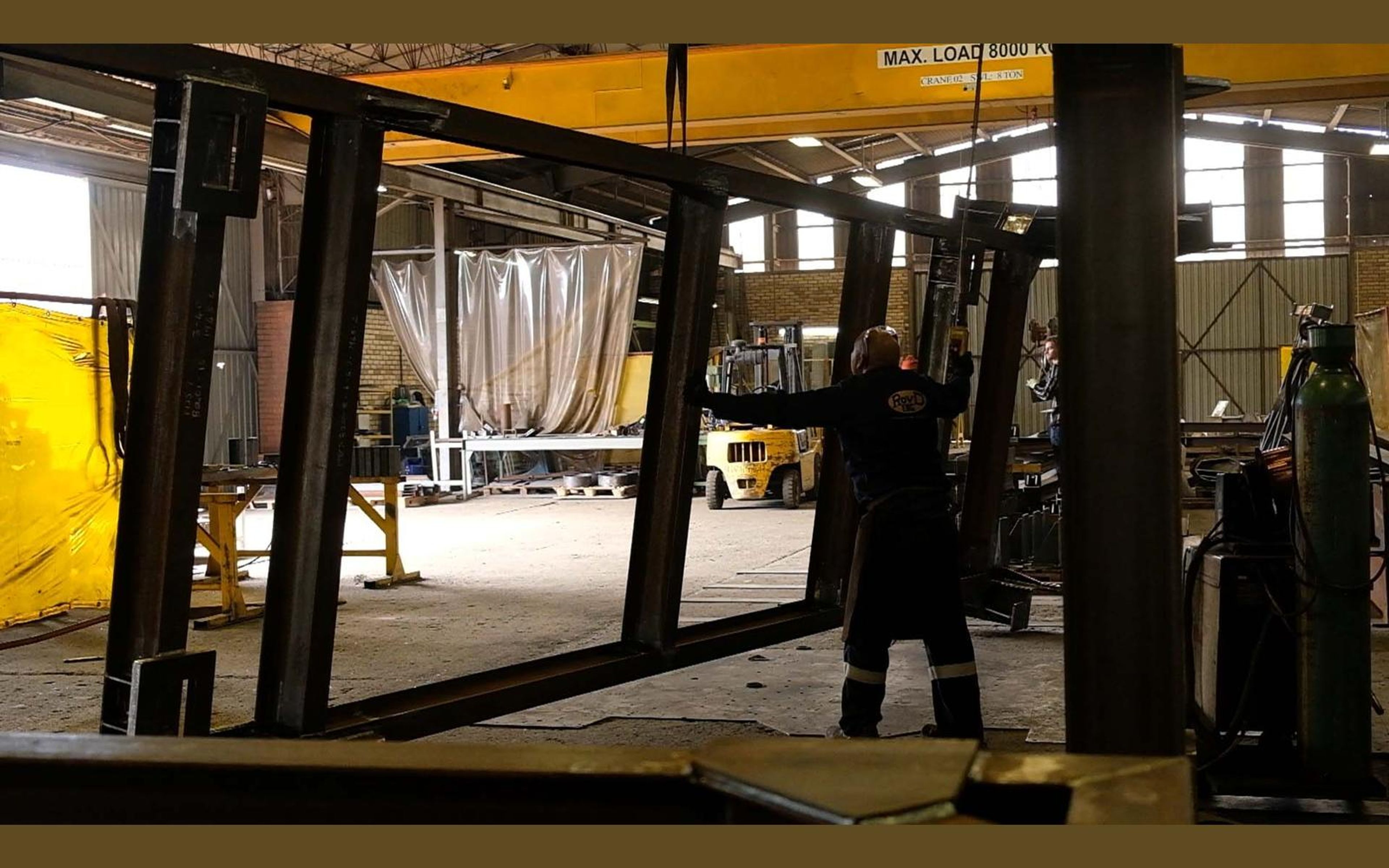 Wide view of the fabrication sector with steel frames on the floor