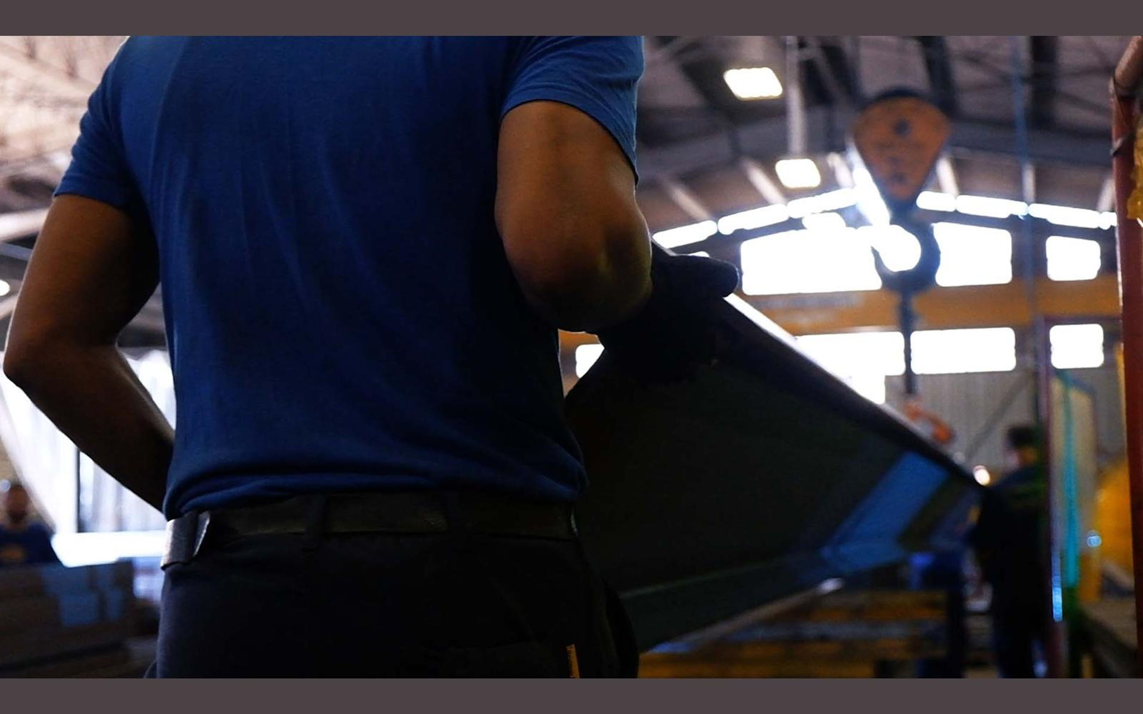 Hands working on a steel part in the fabrication sector