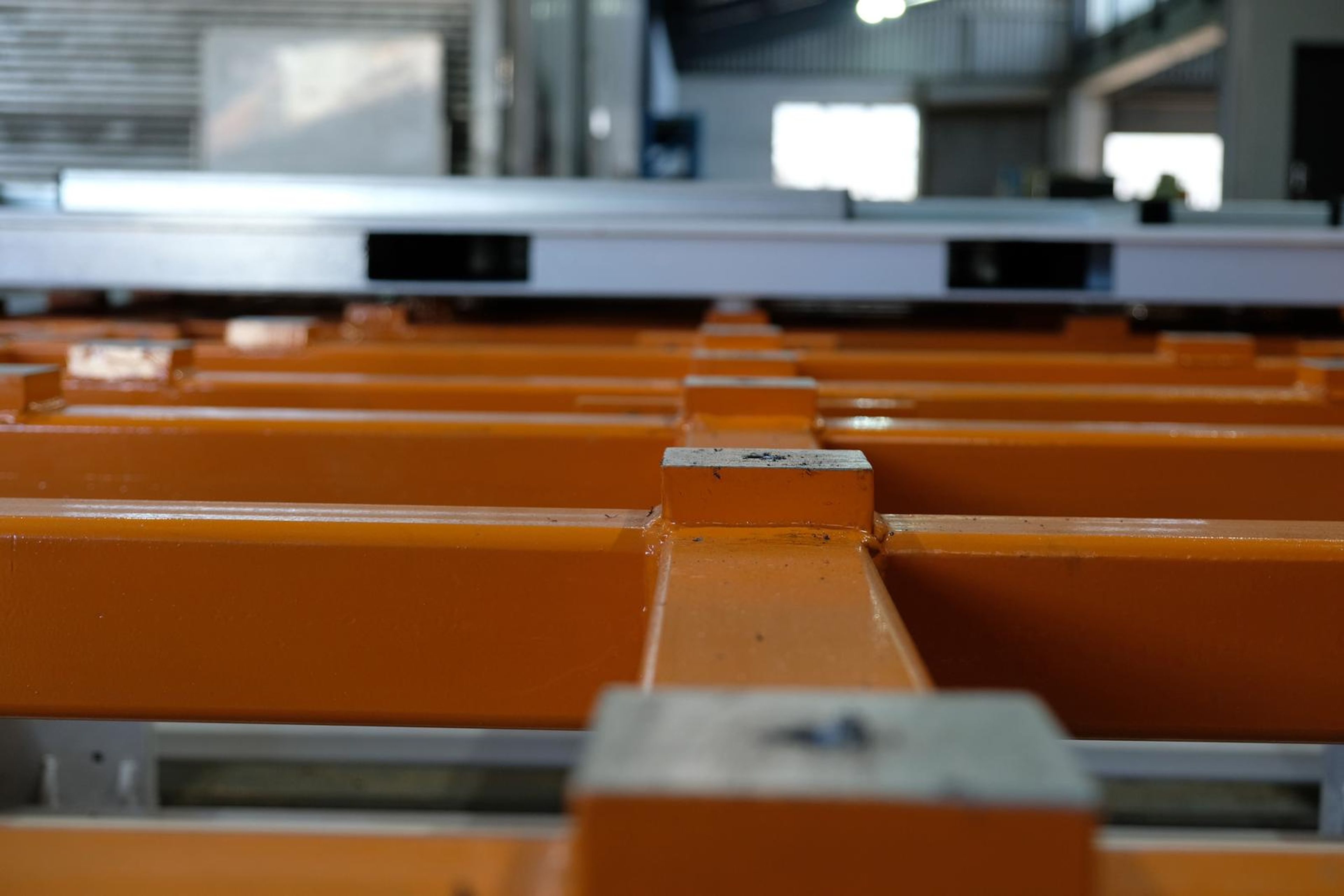Orange frame members and a grey block in close focus