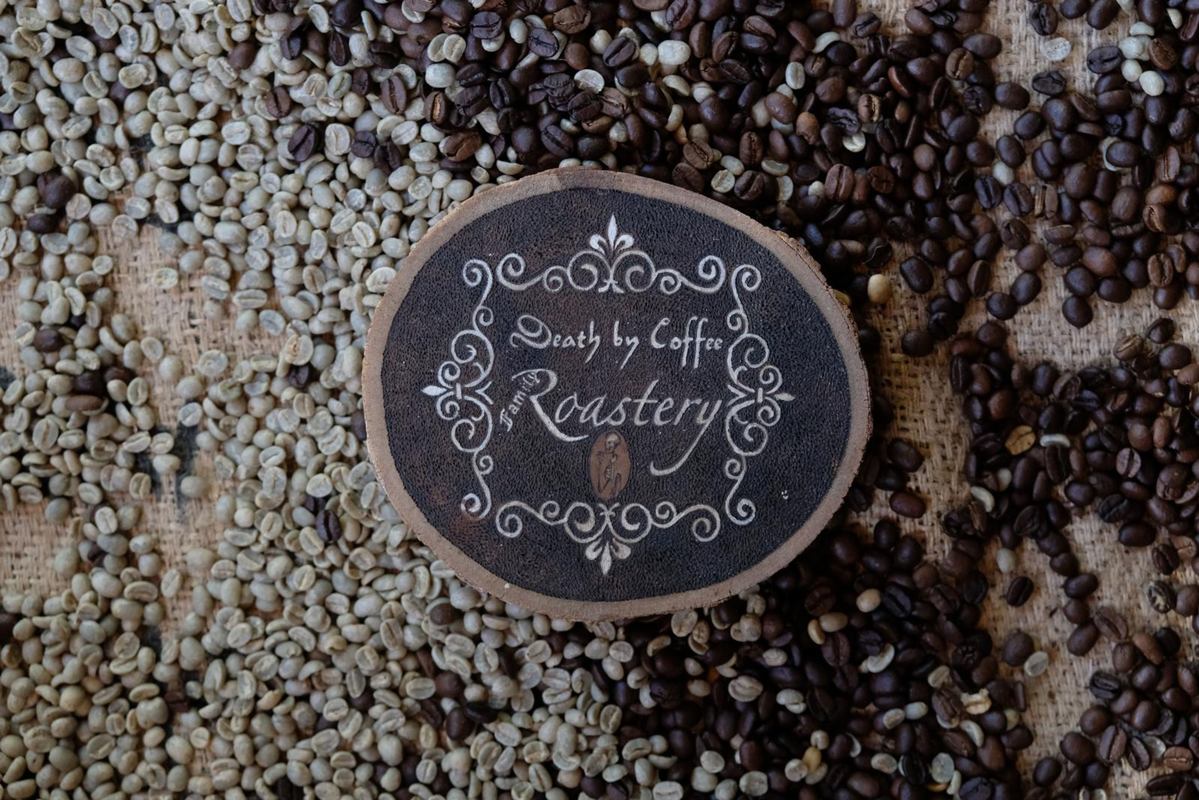 Death By Coffee creative product photography of coffee, beans and branded bags