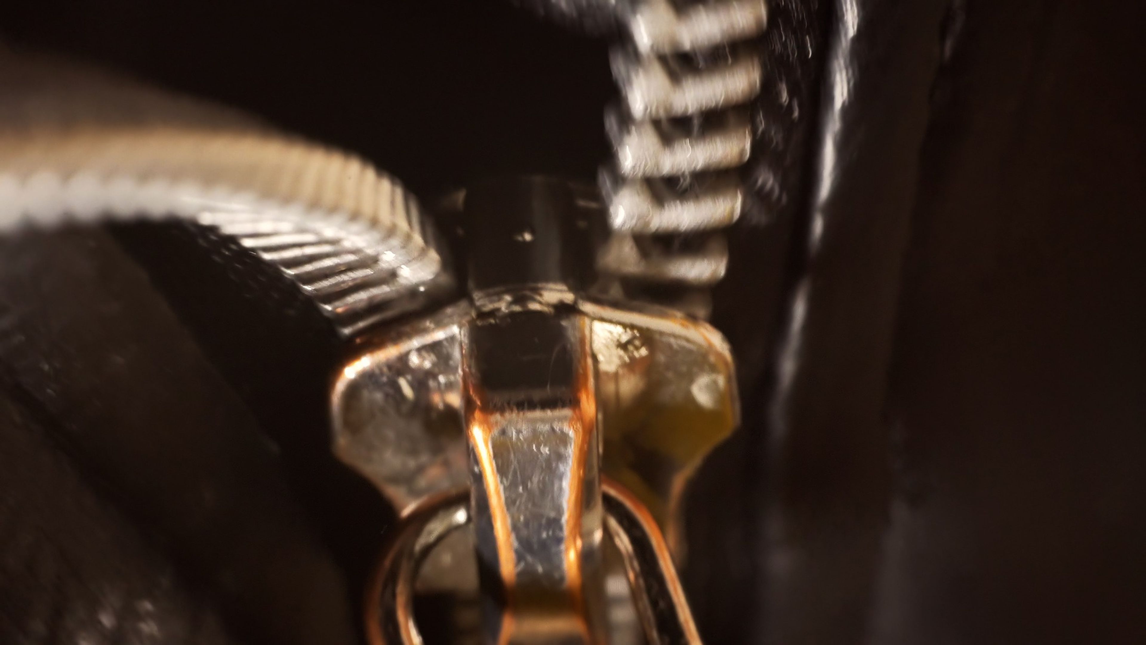Extreme close-up of a gold zipper