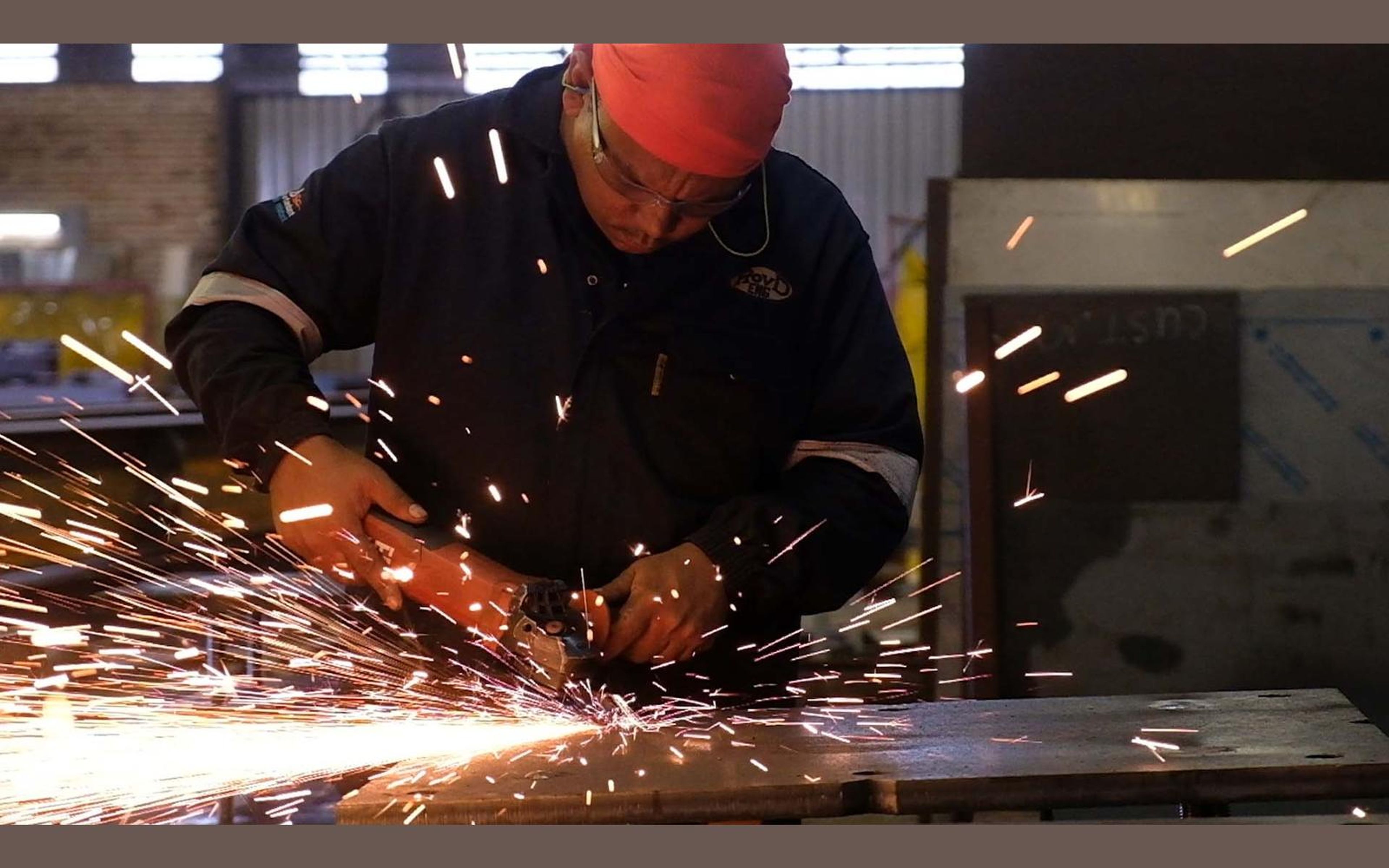 Grinder throwing sparks across steel