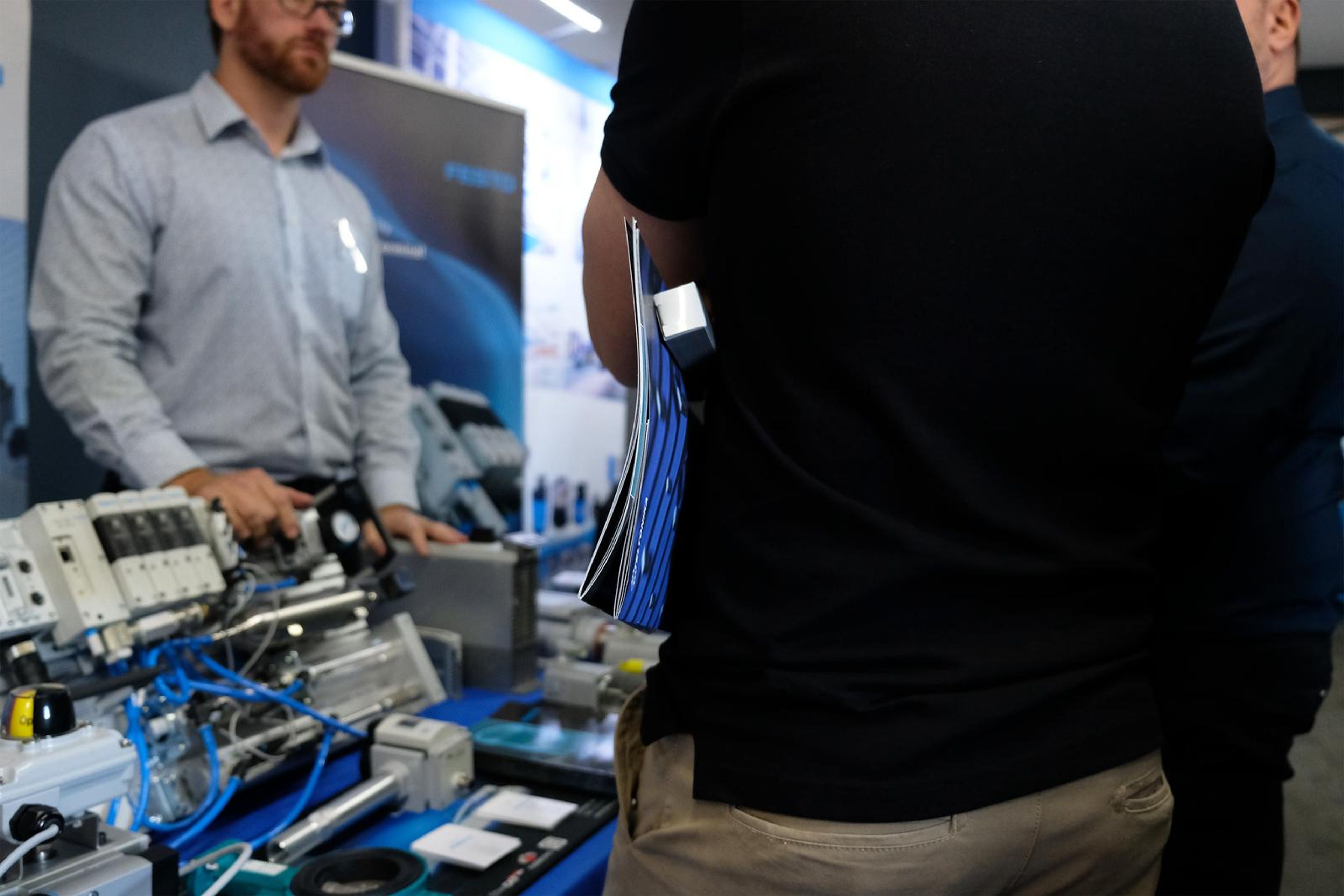 Festo presenter explaining a pneumatic demonstration at the stand