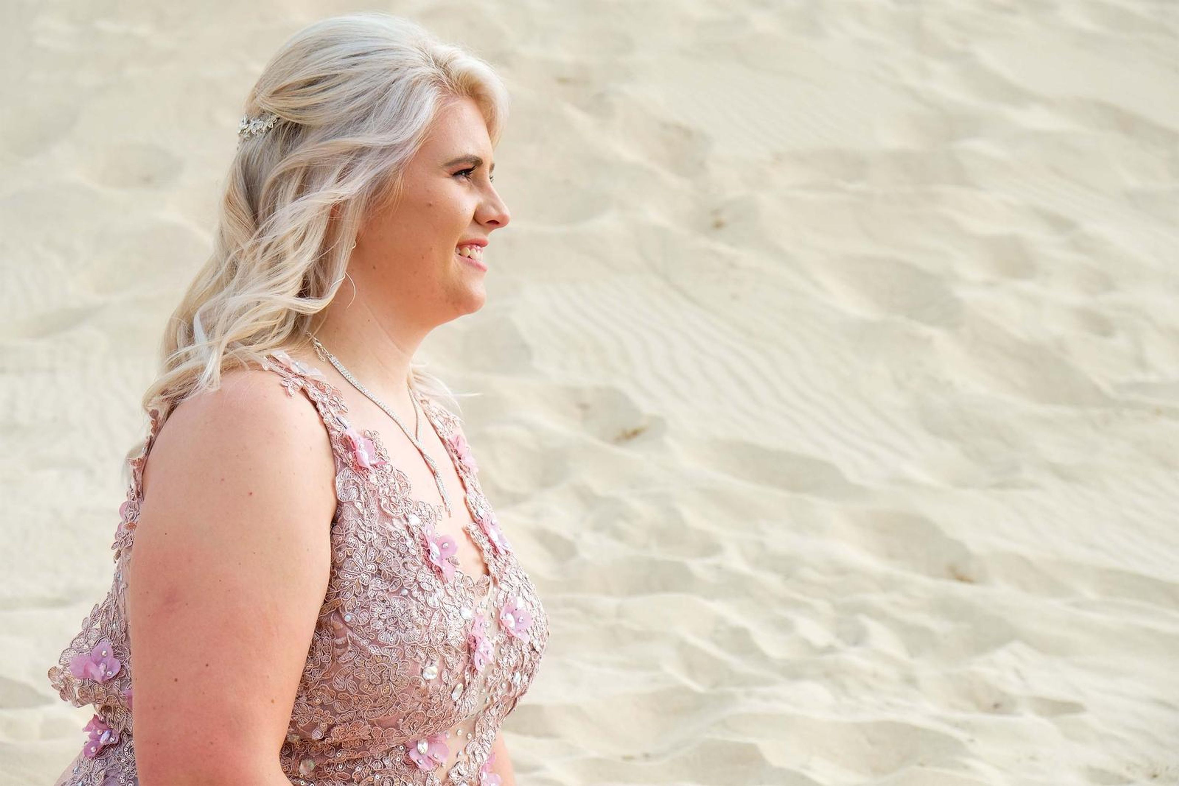 Profile portrait on the sand, smiling