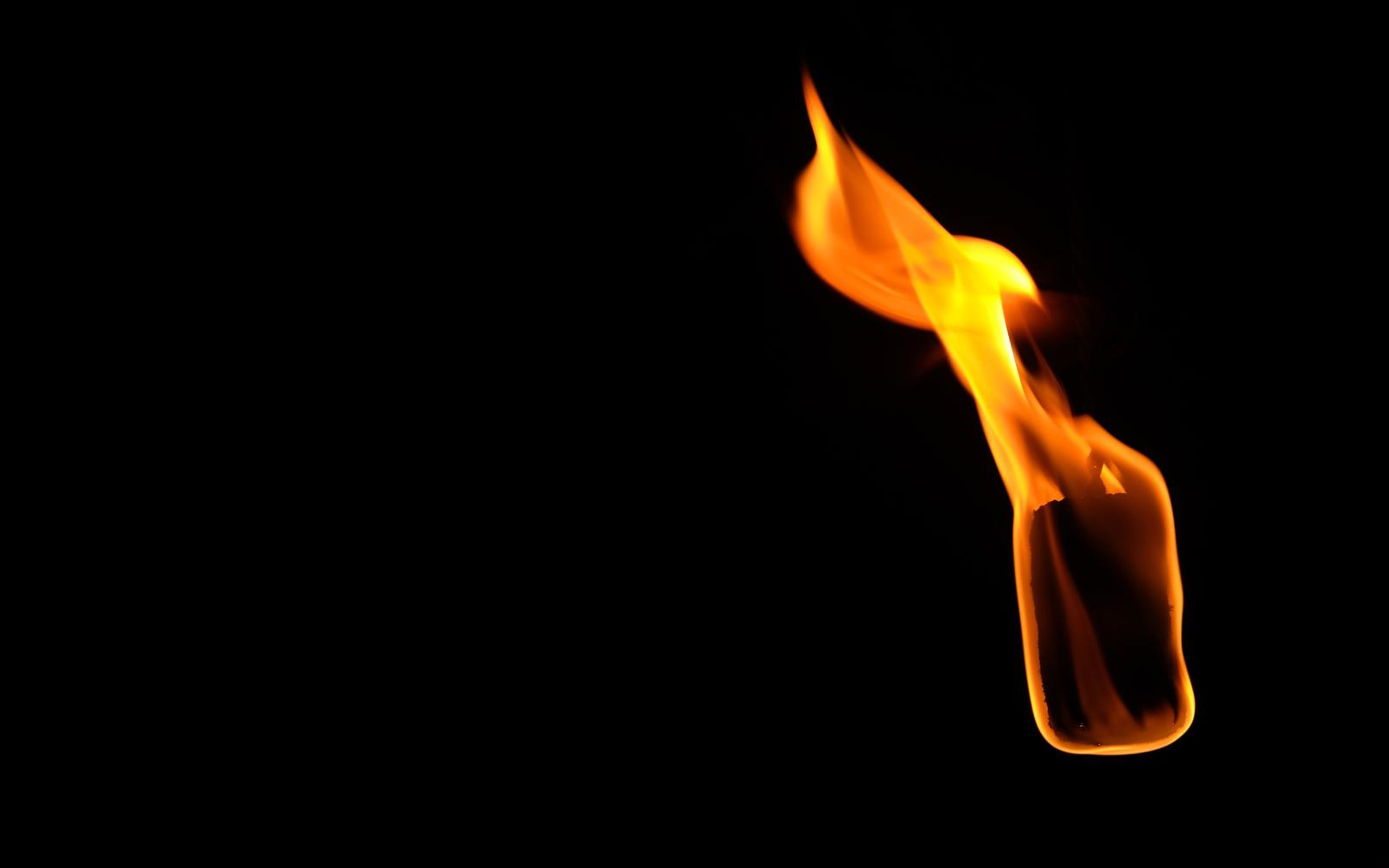 Narrow flame at the upper right with a pointed tip and a smooth rounded base