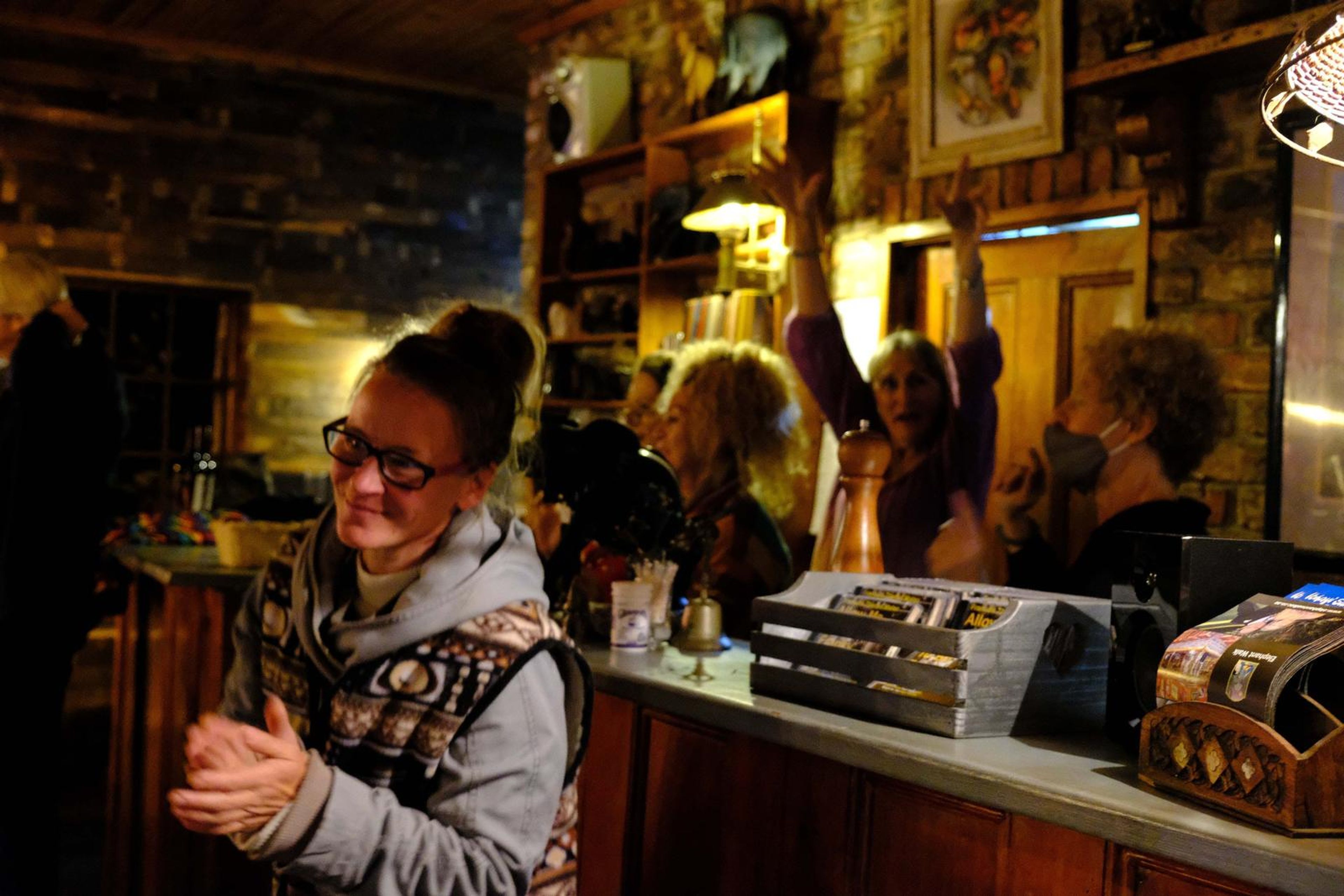 Guest laughing and clapping at the bar