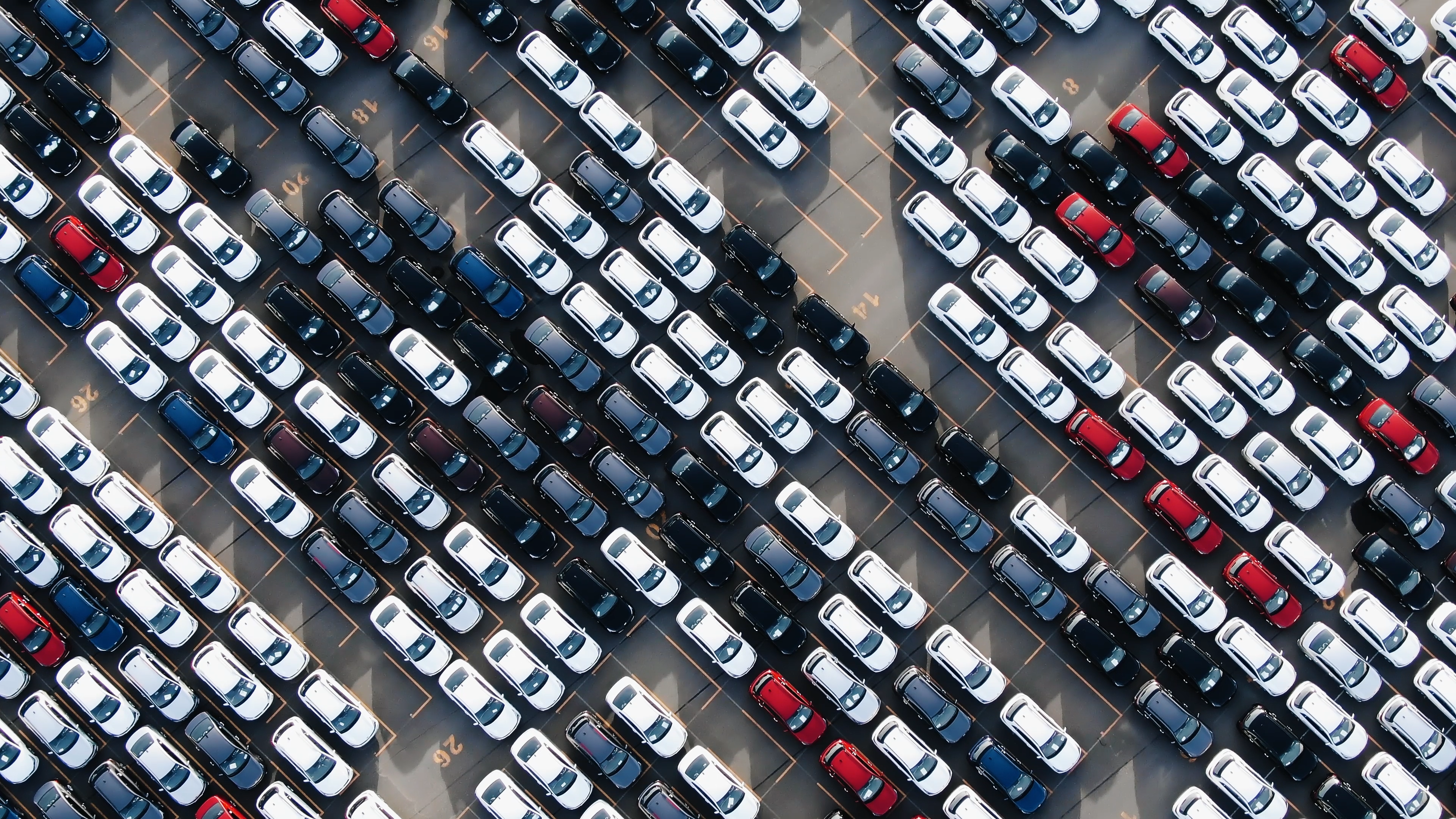Aerial view of a car park full of new vehicles