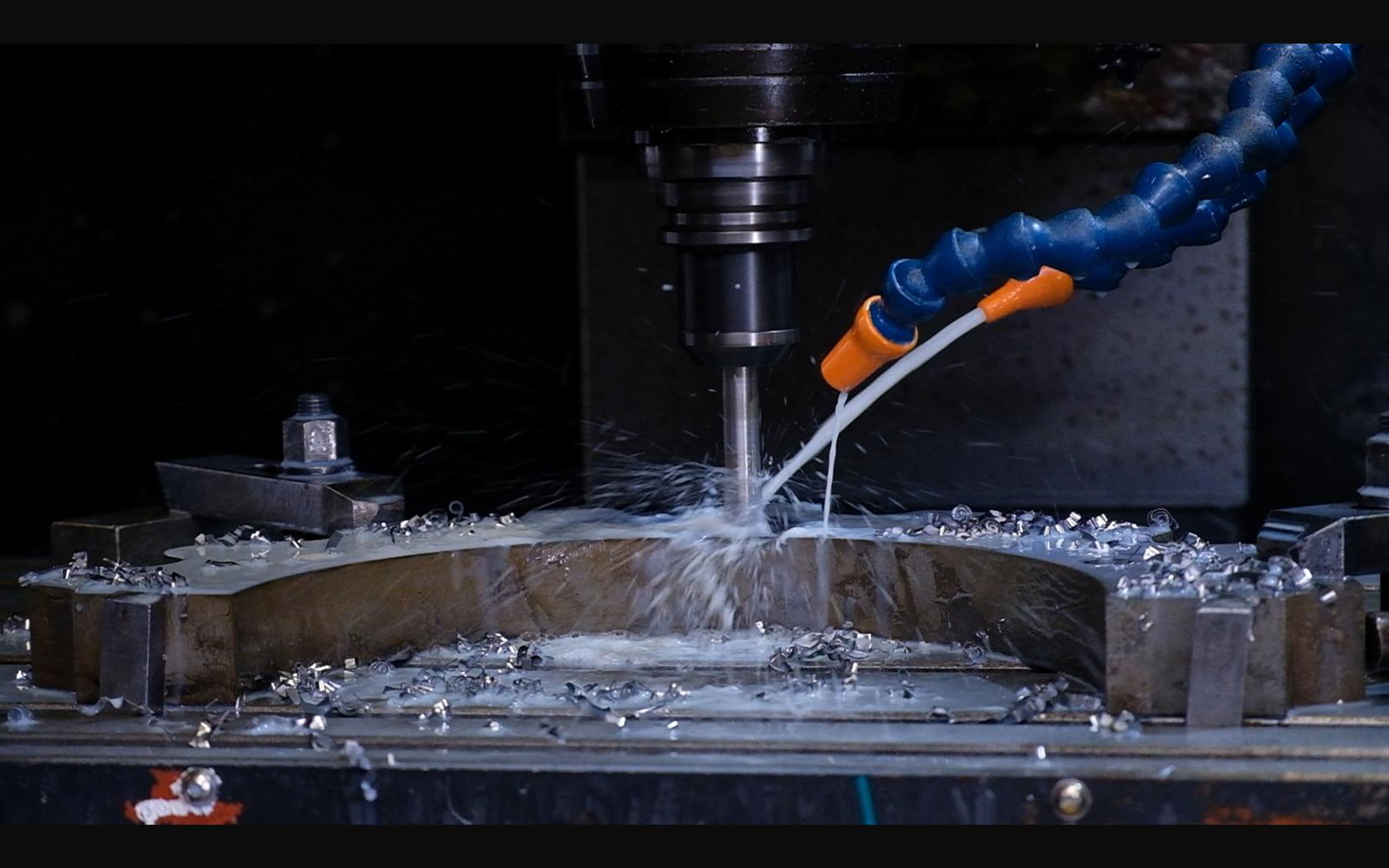 Coolant washing over a circular part being machined