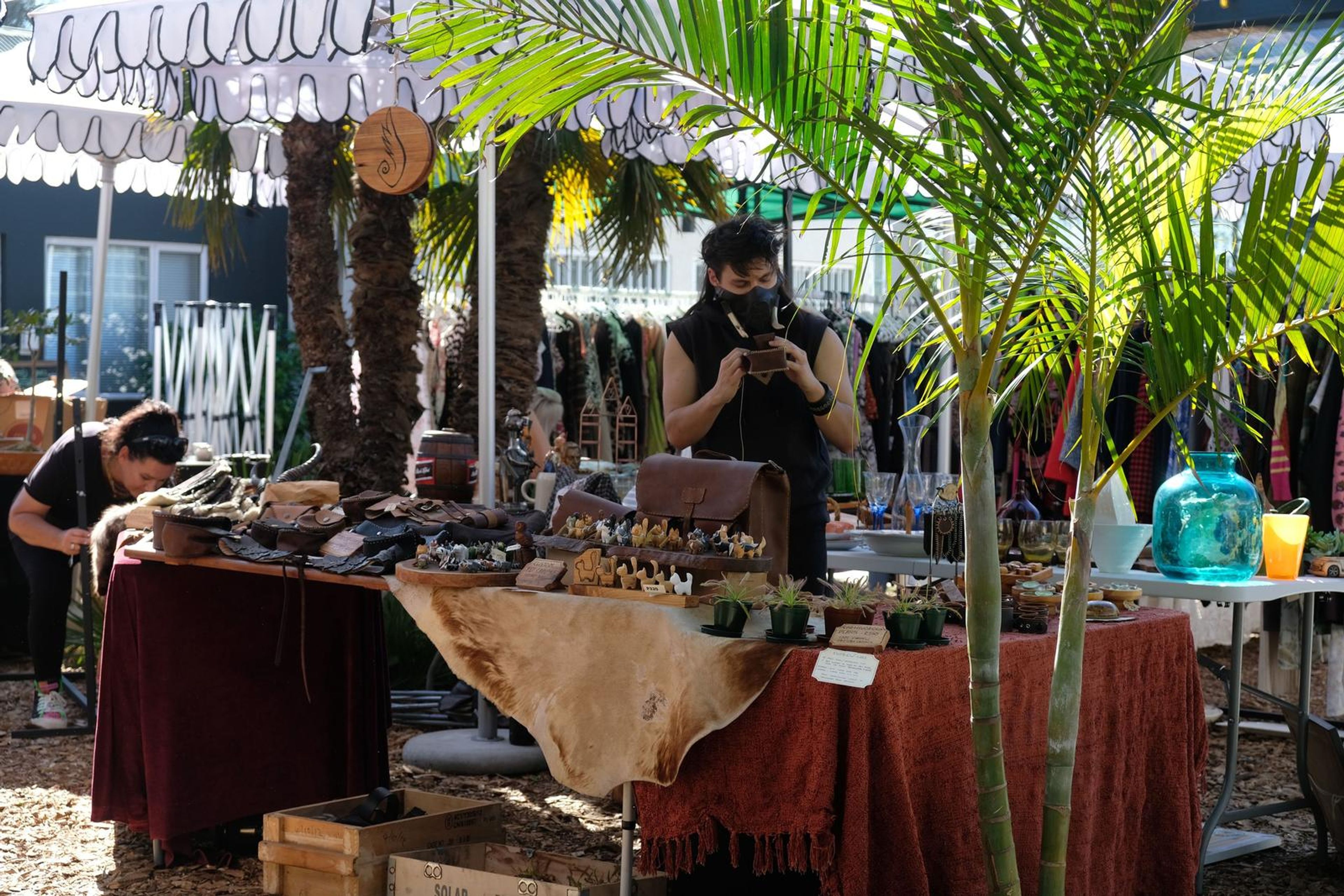 Juuks stall under a palm tree at Filthy McNasty's market