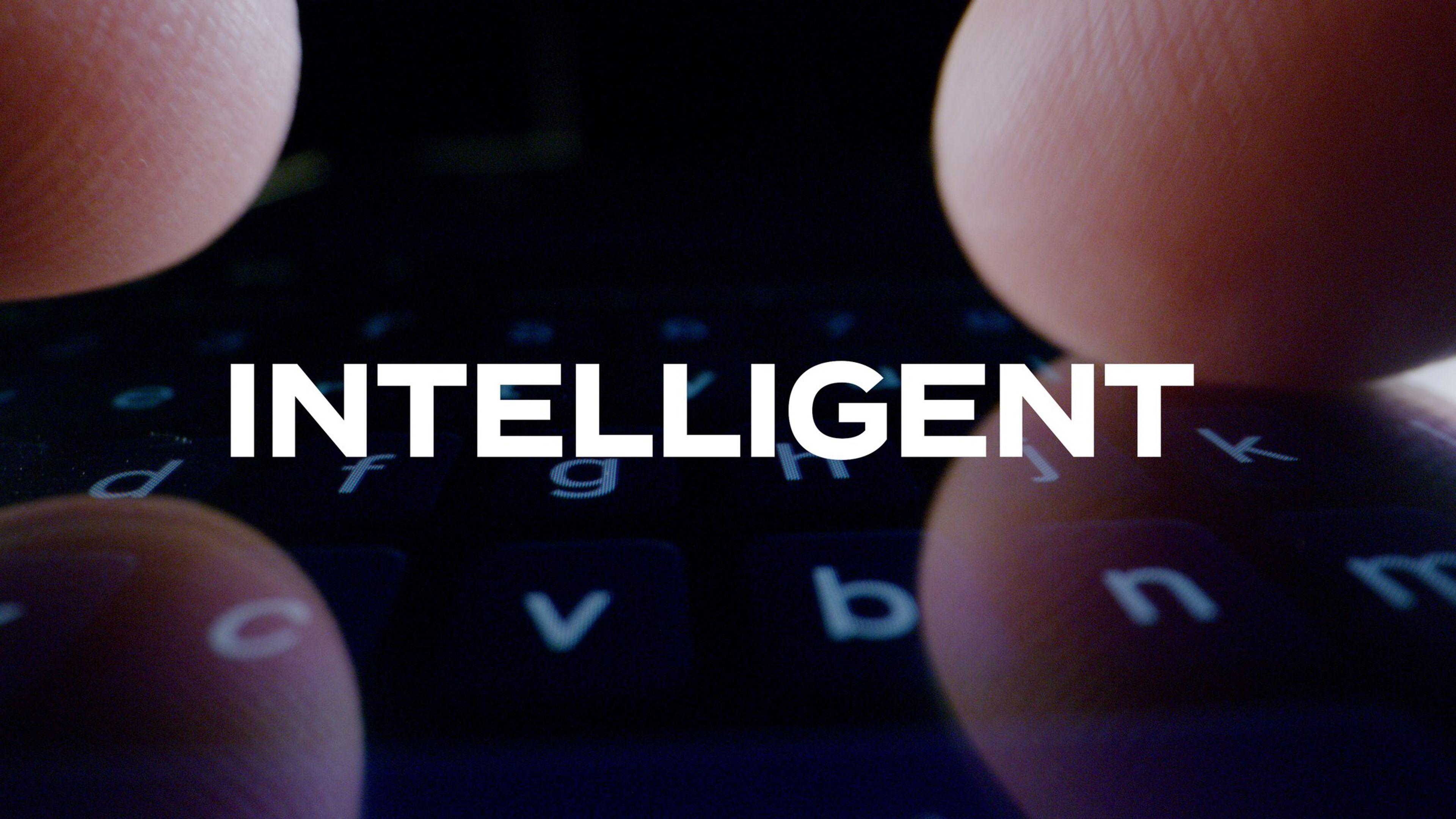 Soft-focus keyboard behind the text 'Intelligent'