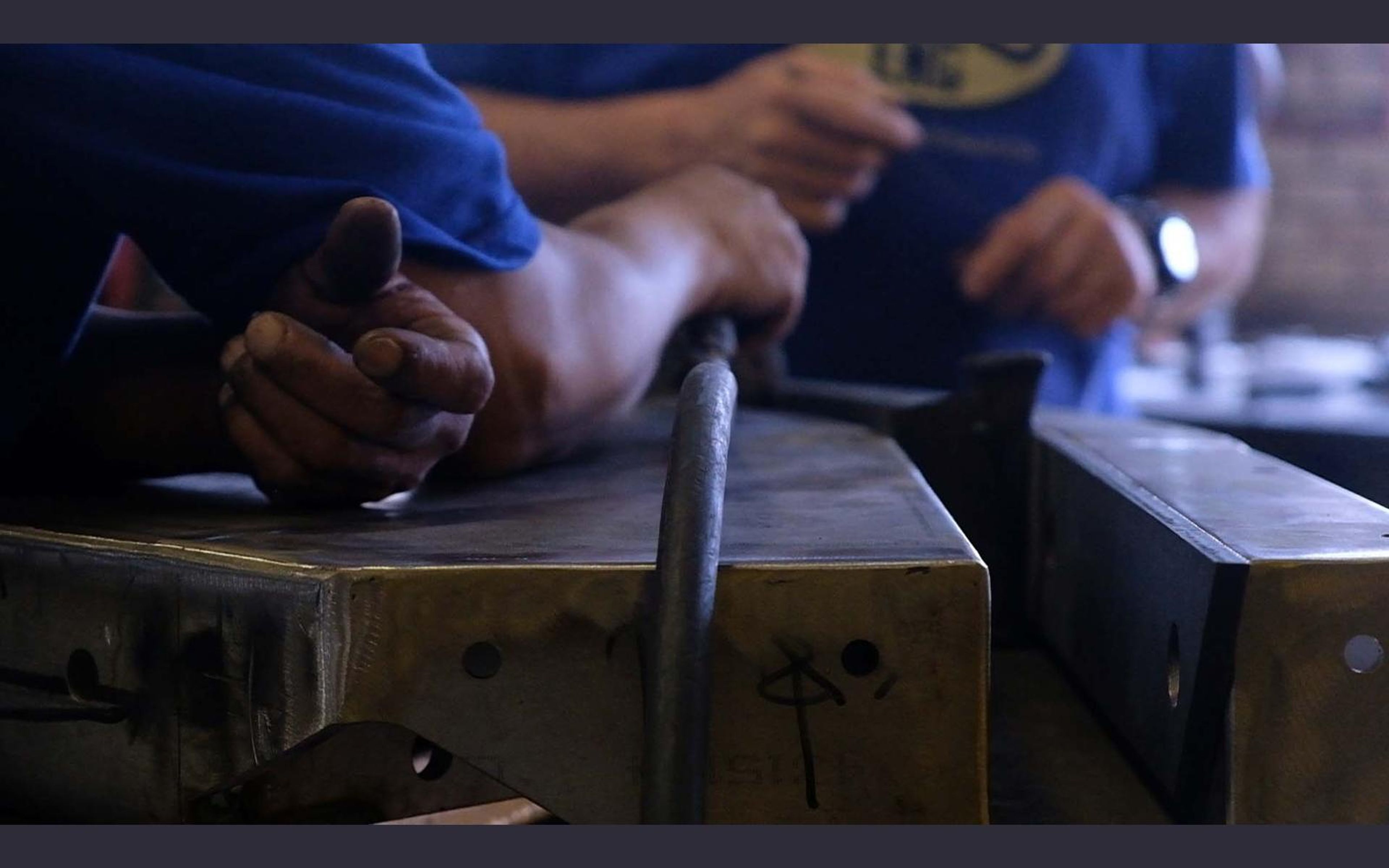 Team members working on a steel assembly