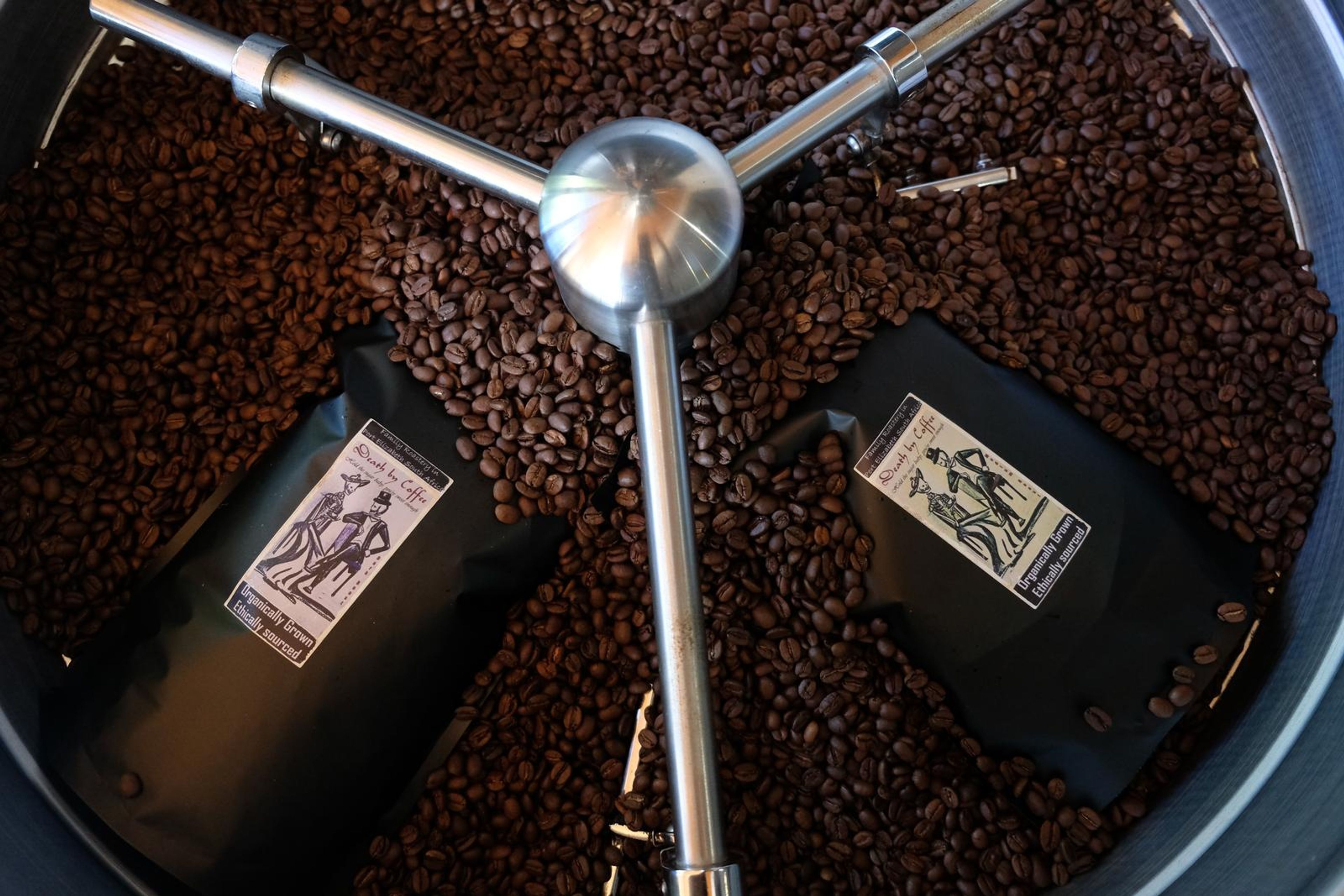 Death By Coffee creative product photography of coffee, beans and branded bags
