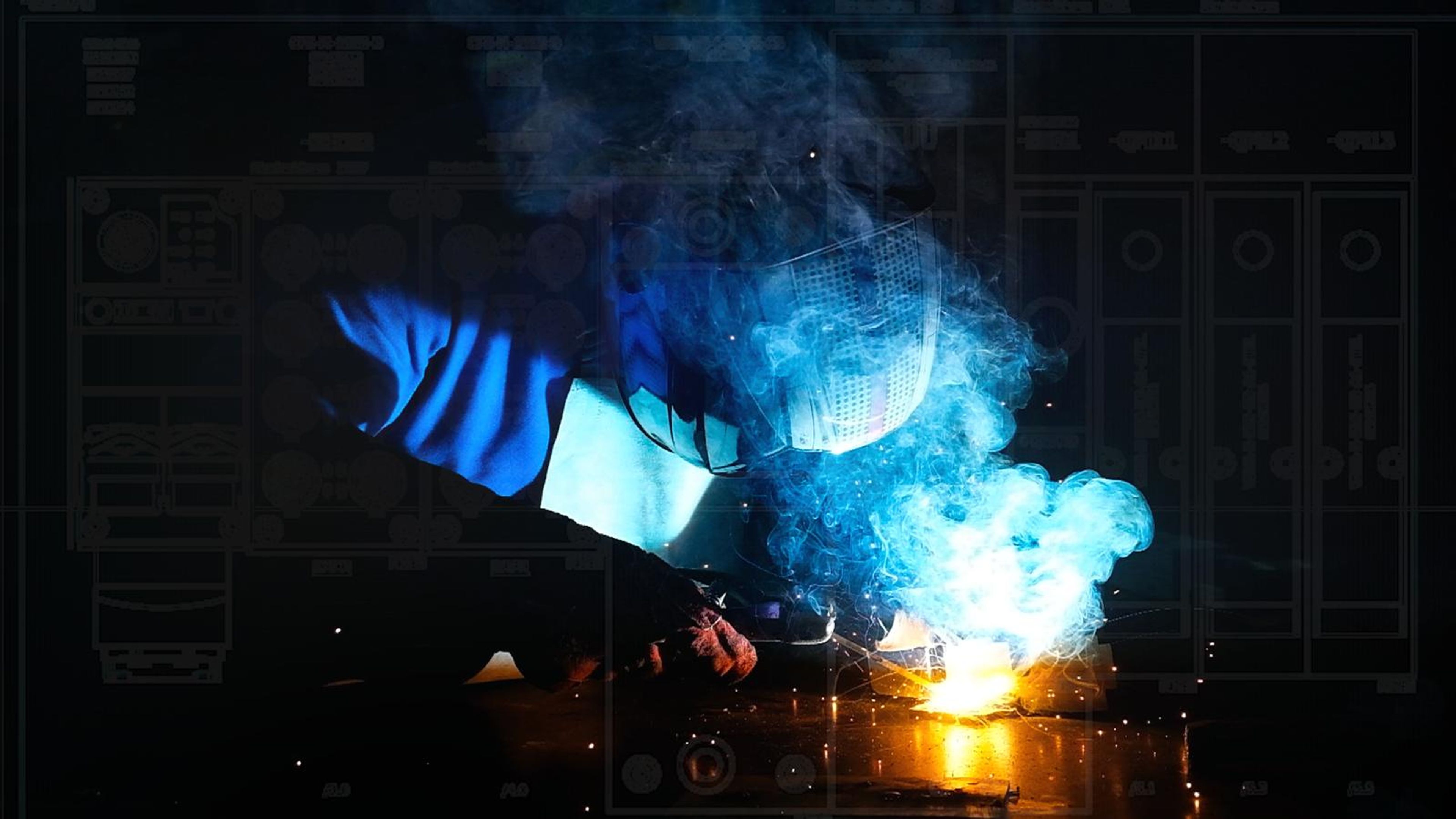 Welding arc with blue smoke over a faint control panel drawing