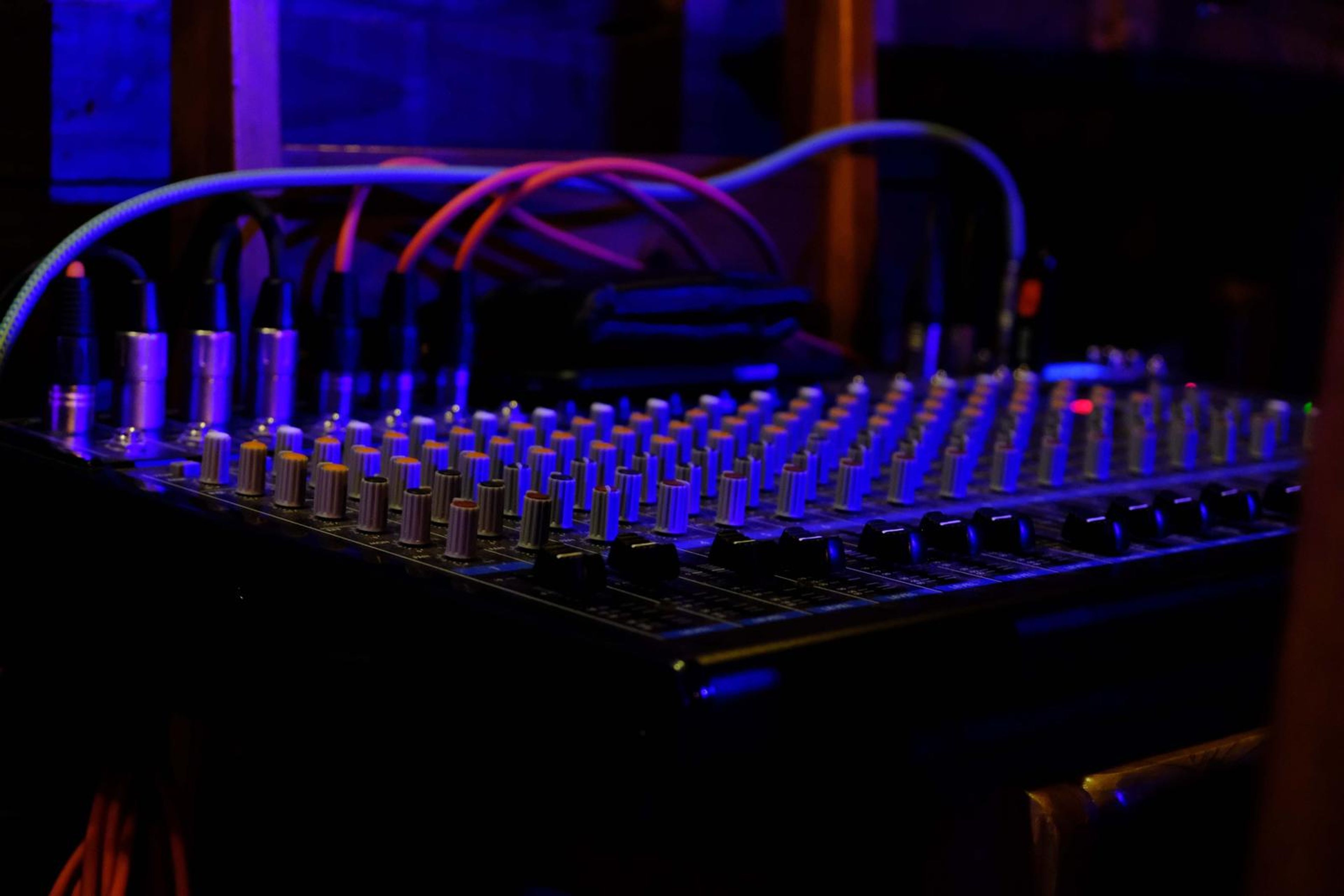 Sound desk with faders glowing blue