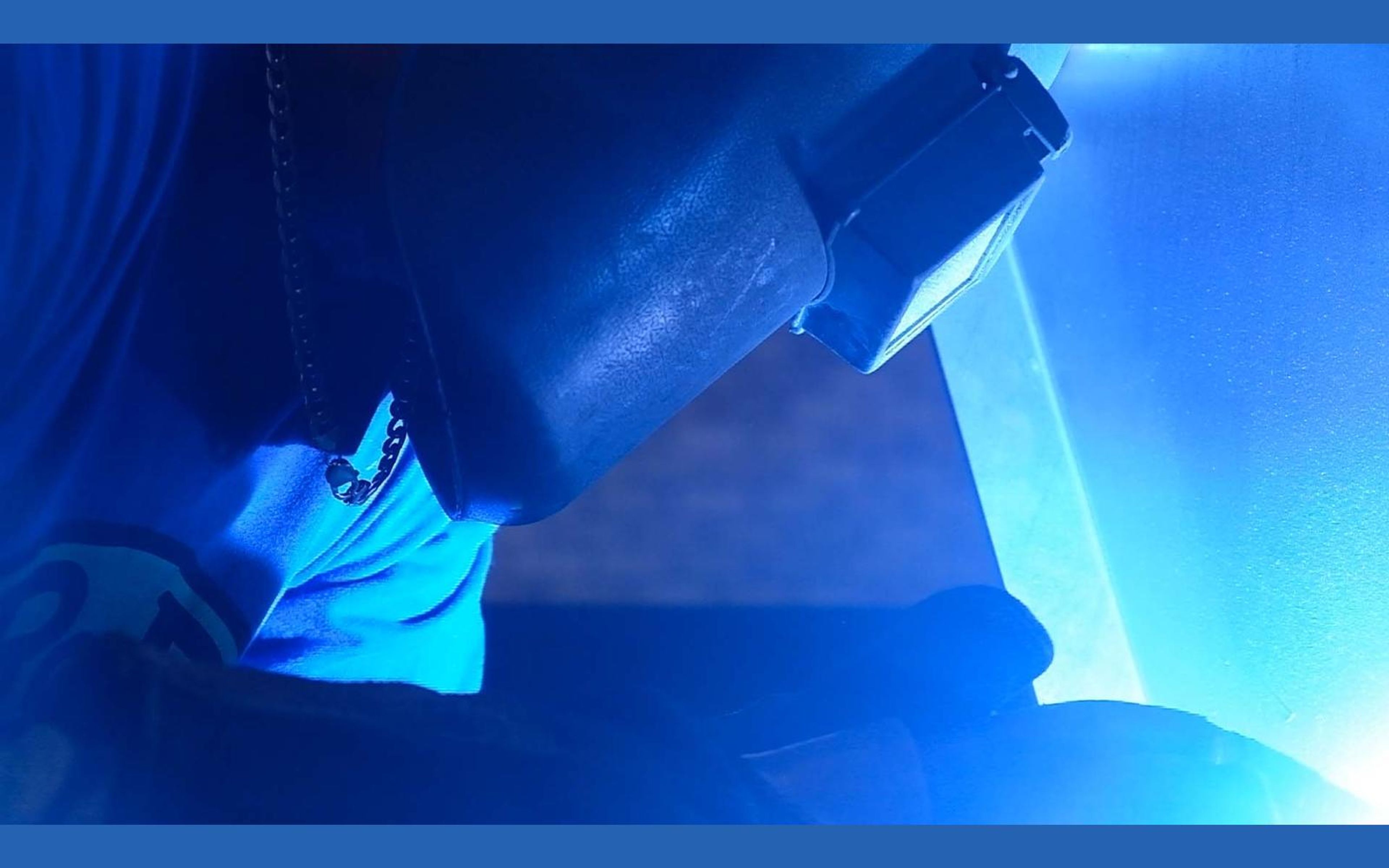 Welding glow lighting the steel and the welder's mask