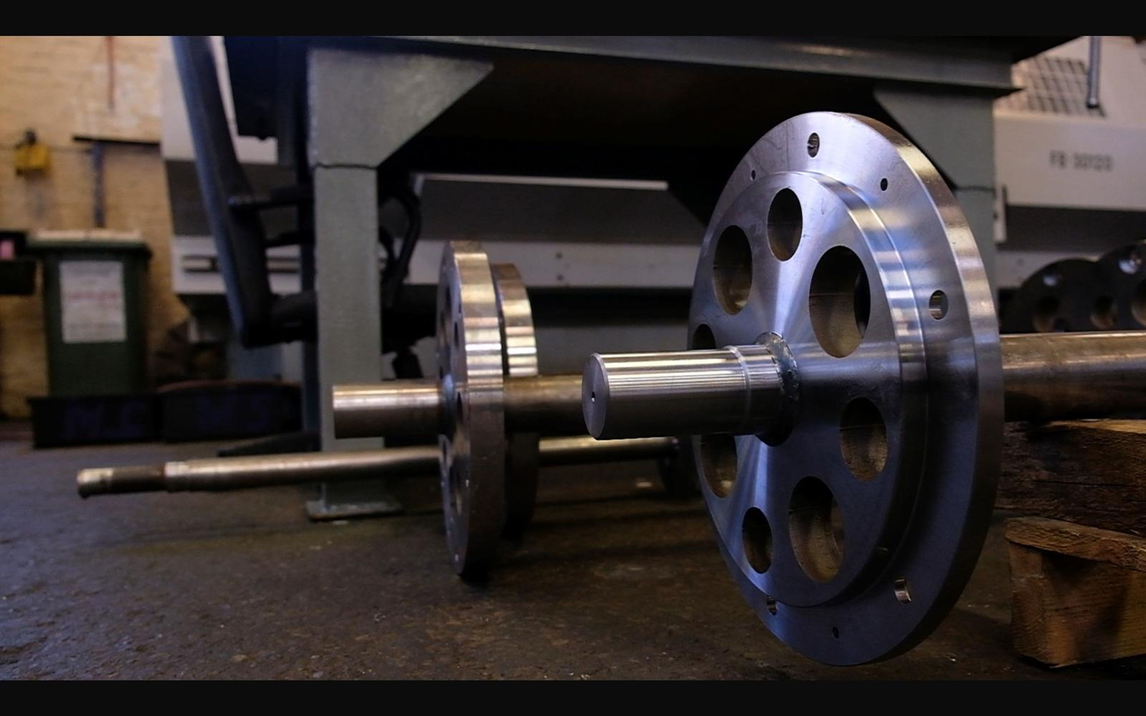 Machined steel wheels on a long shaft