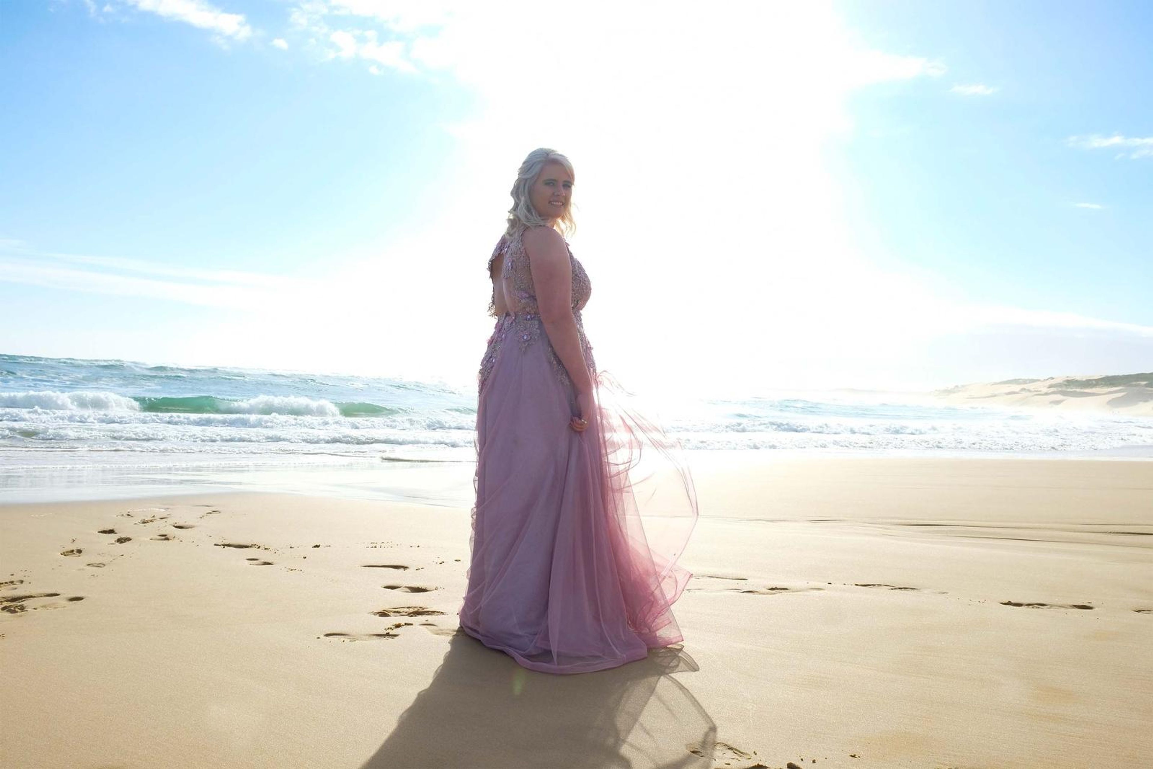 Backlit by the low sun in the pink gown