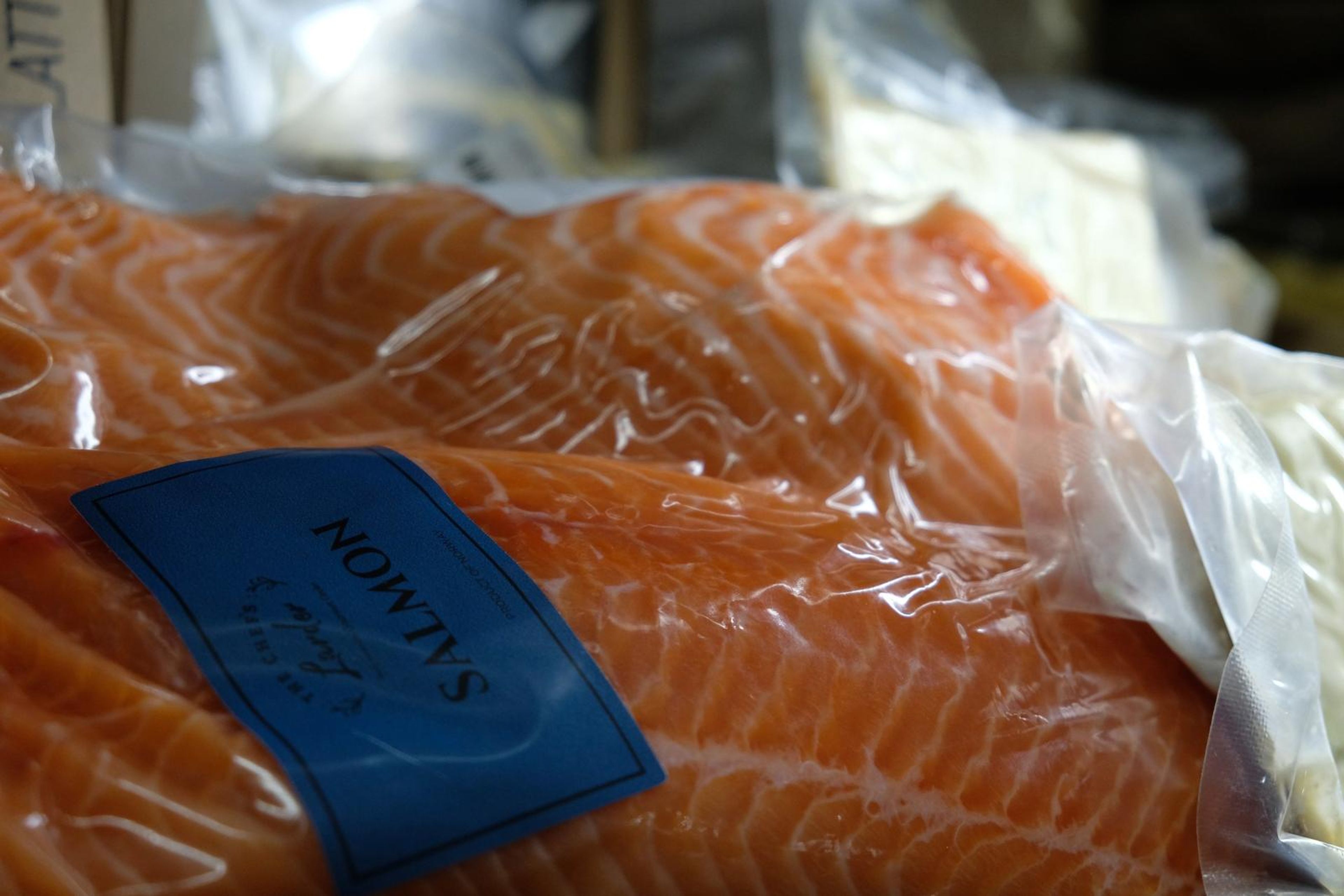 Close-up of vacuum-packed salmon with a blue label