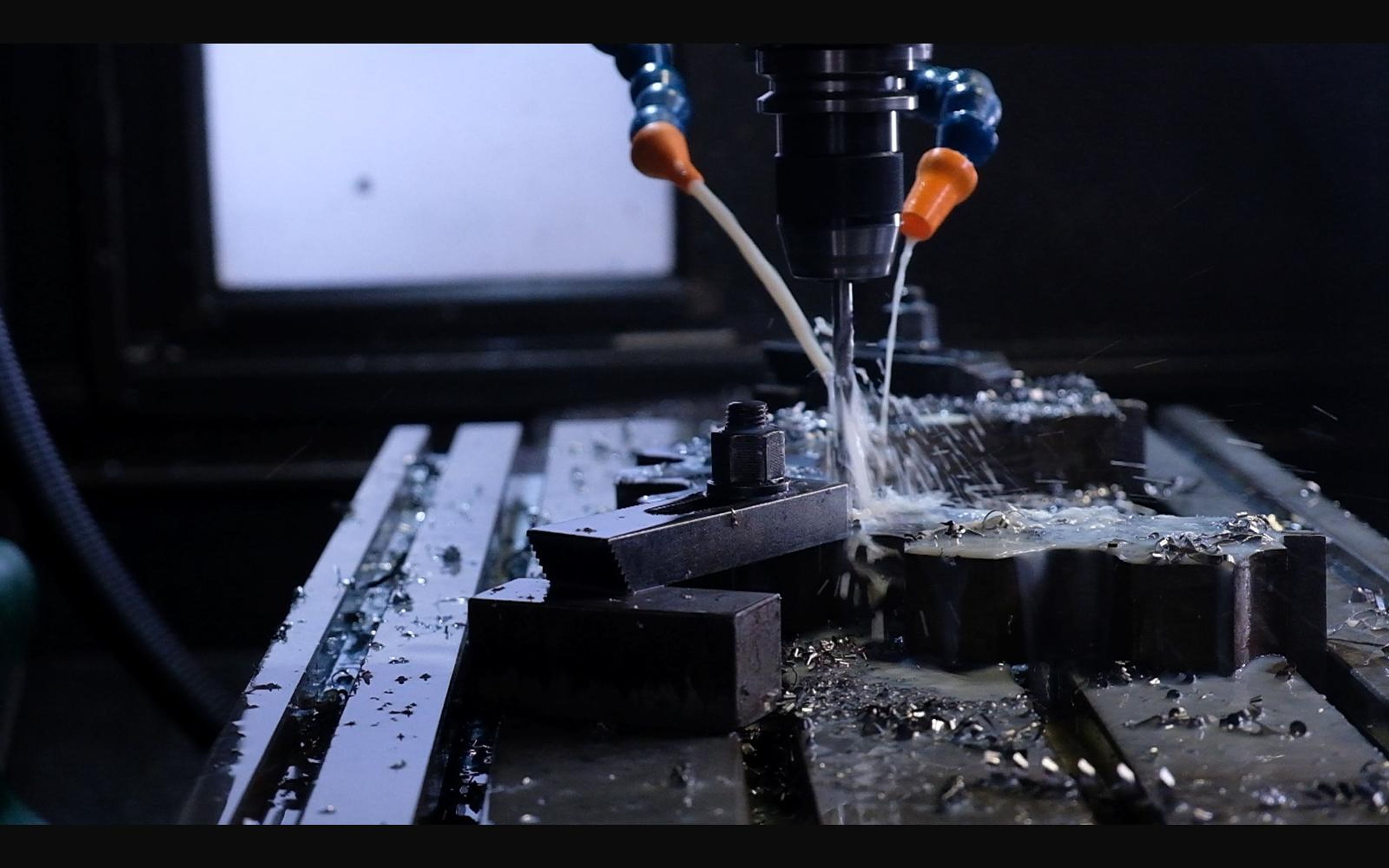 Milling machine at work with coolant