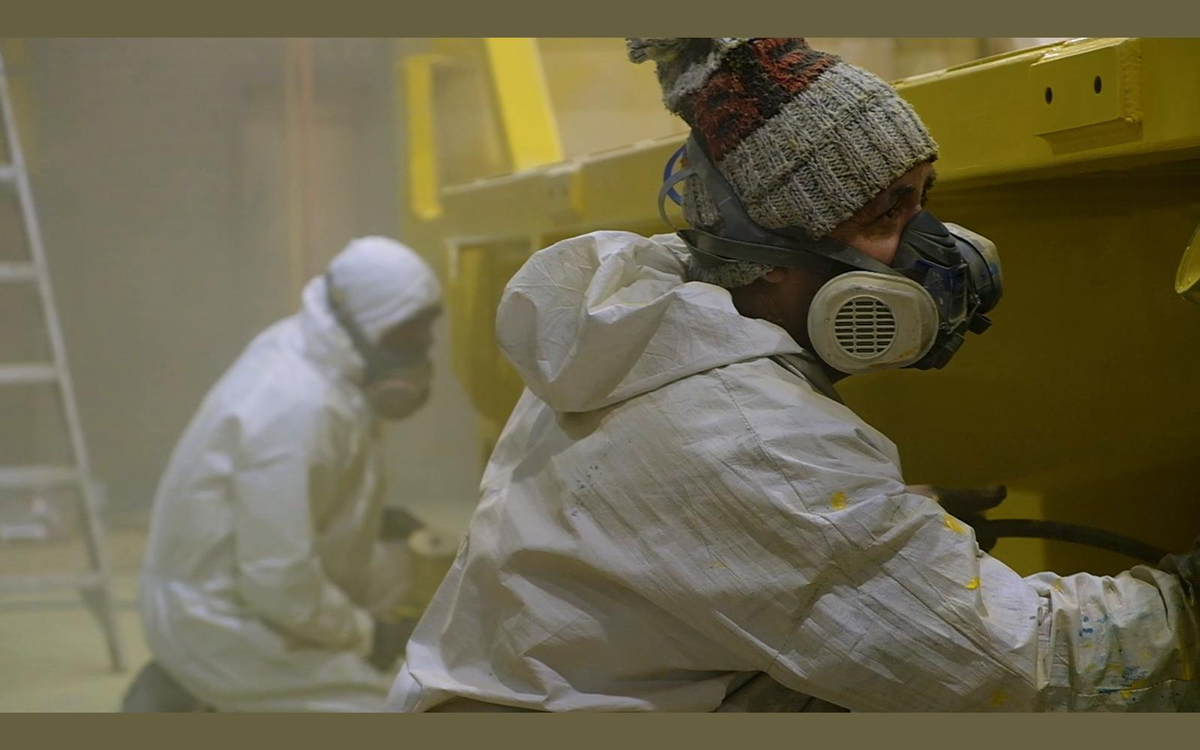 Painter in a respirator and white suit