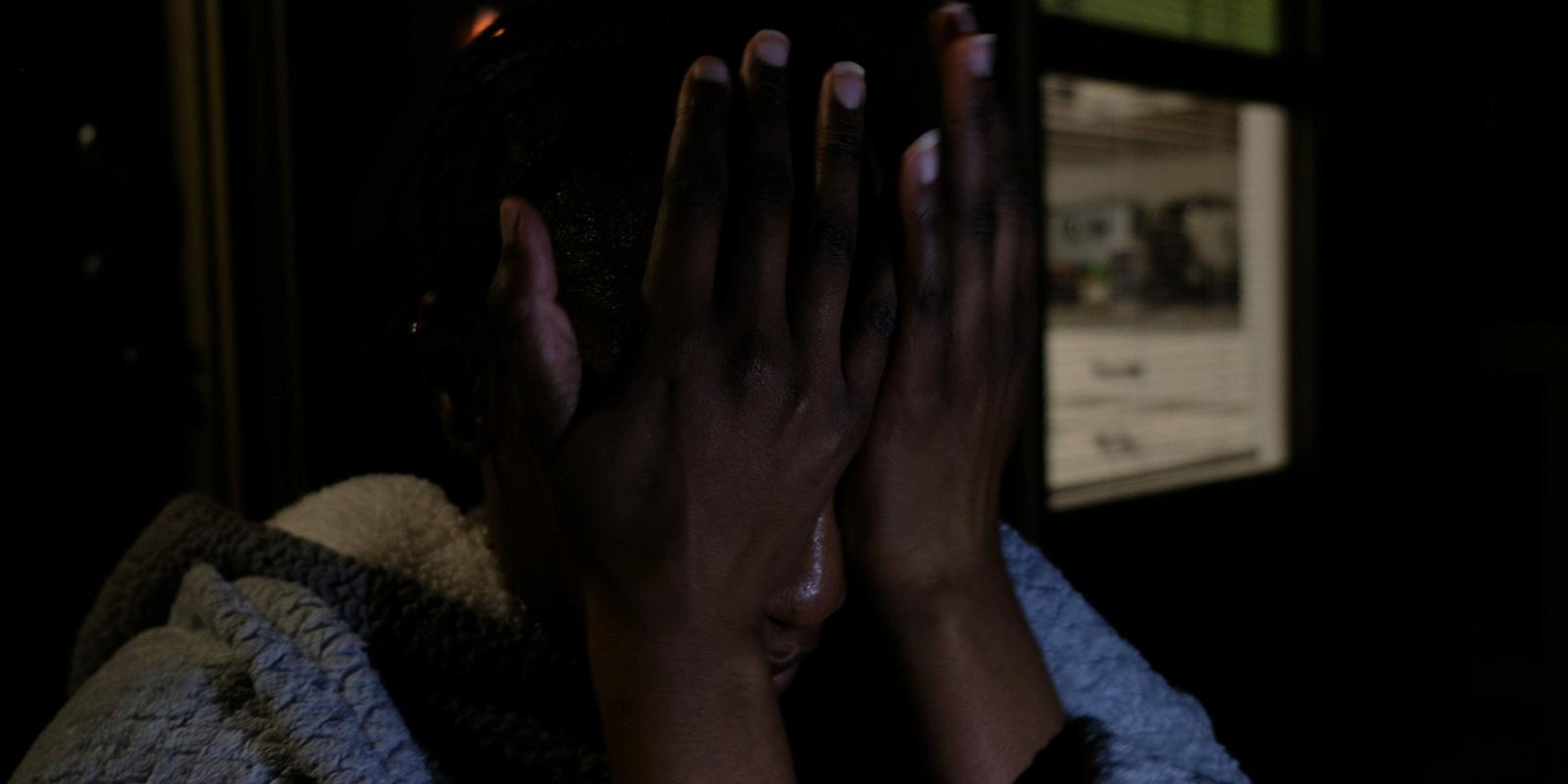 Frame of a woman with her hands over her face after a long search