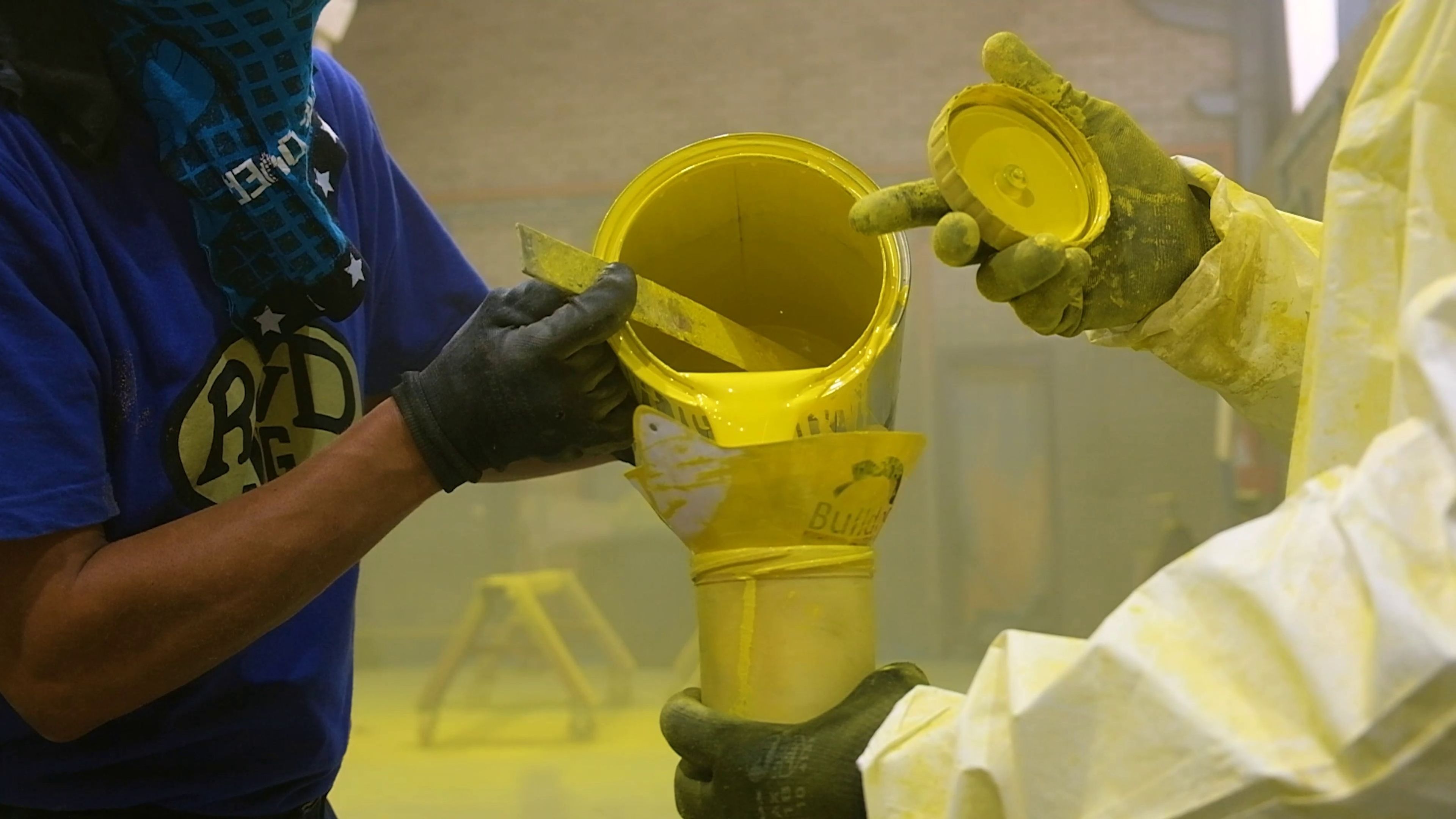 Yellow painted steel chassis in the paint bay