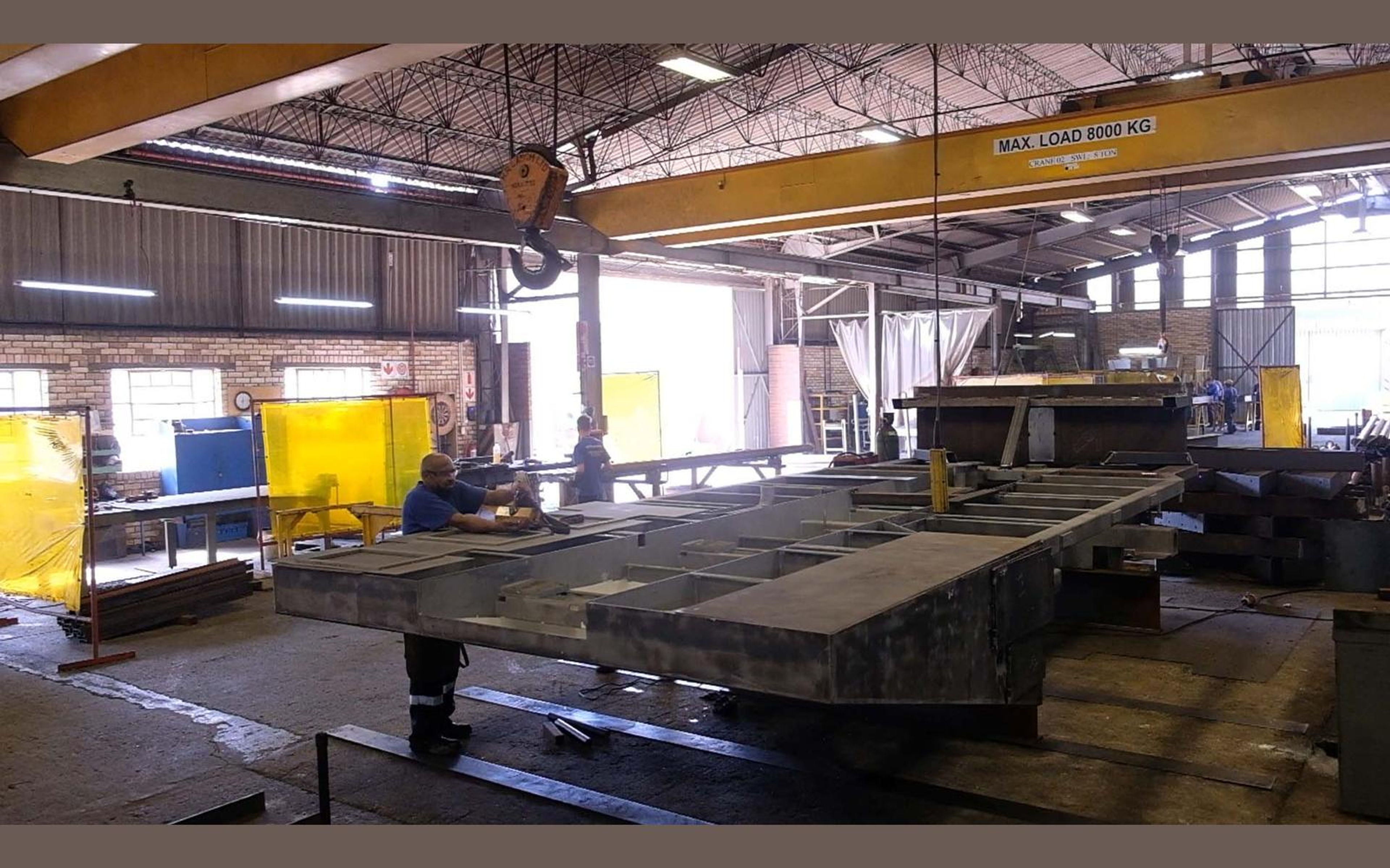 Steel frames laid out across the fabrication sector floor