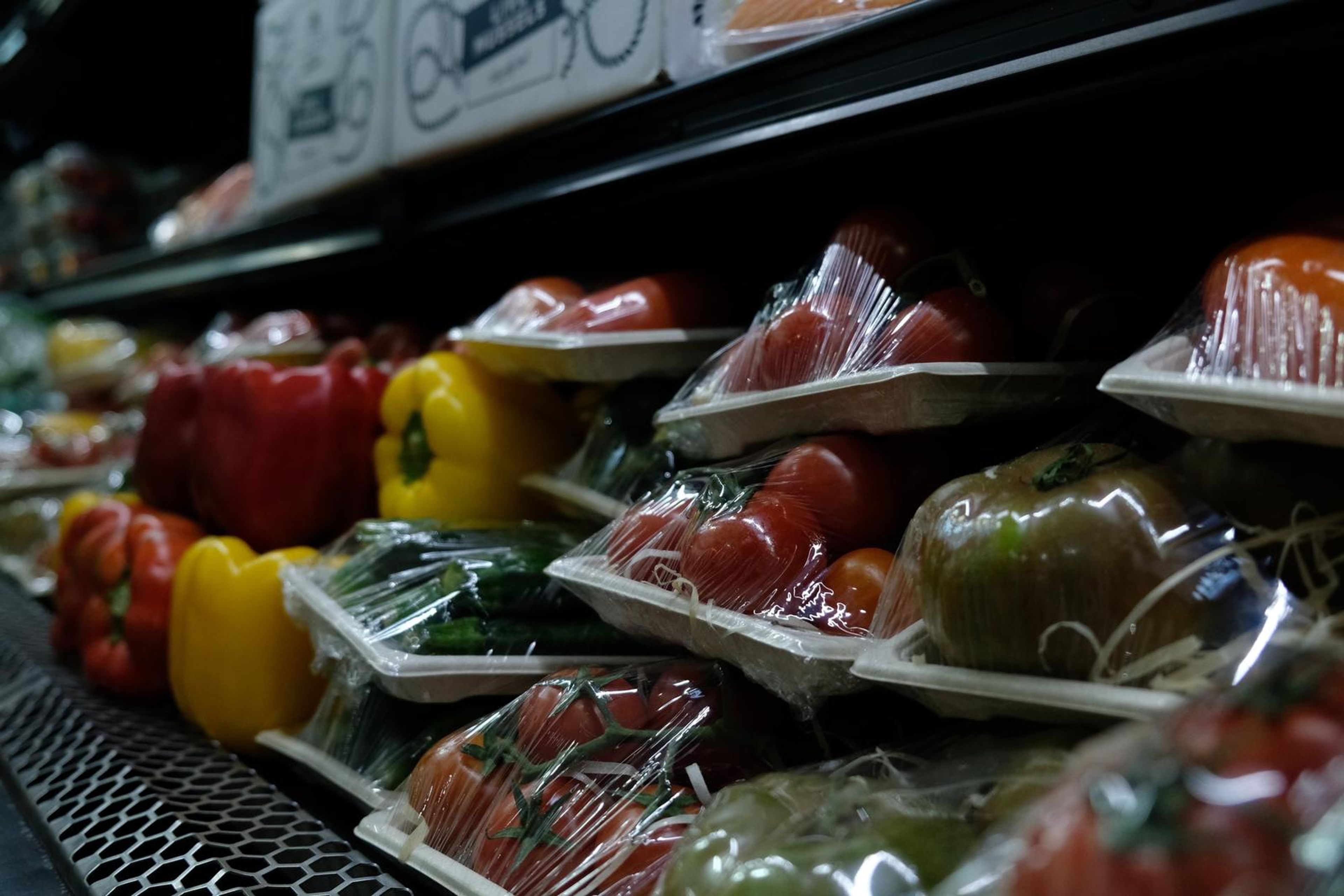 Peppers and tomatoes on the chilled vegetable shelf
