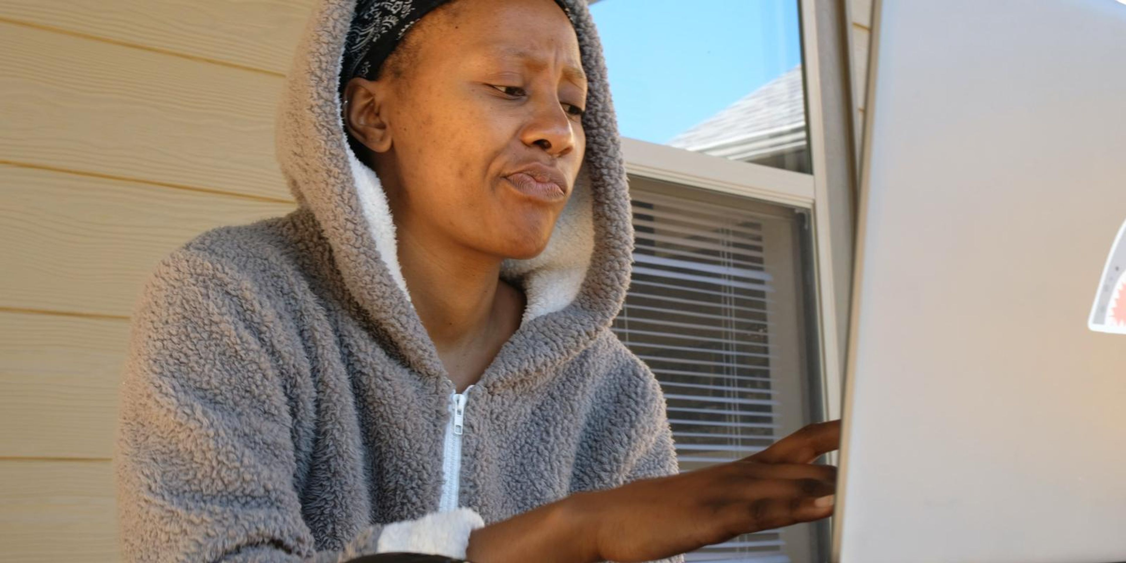 Frame of a woman looking frustrated at a laptop while searching for clothes